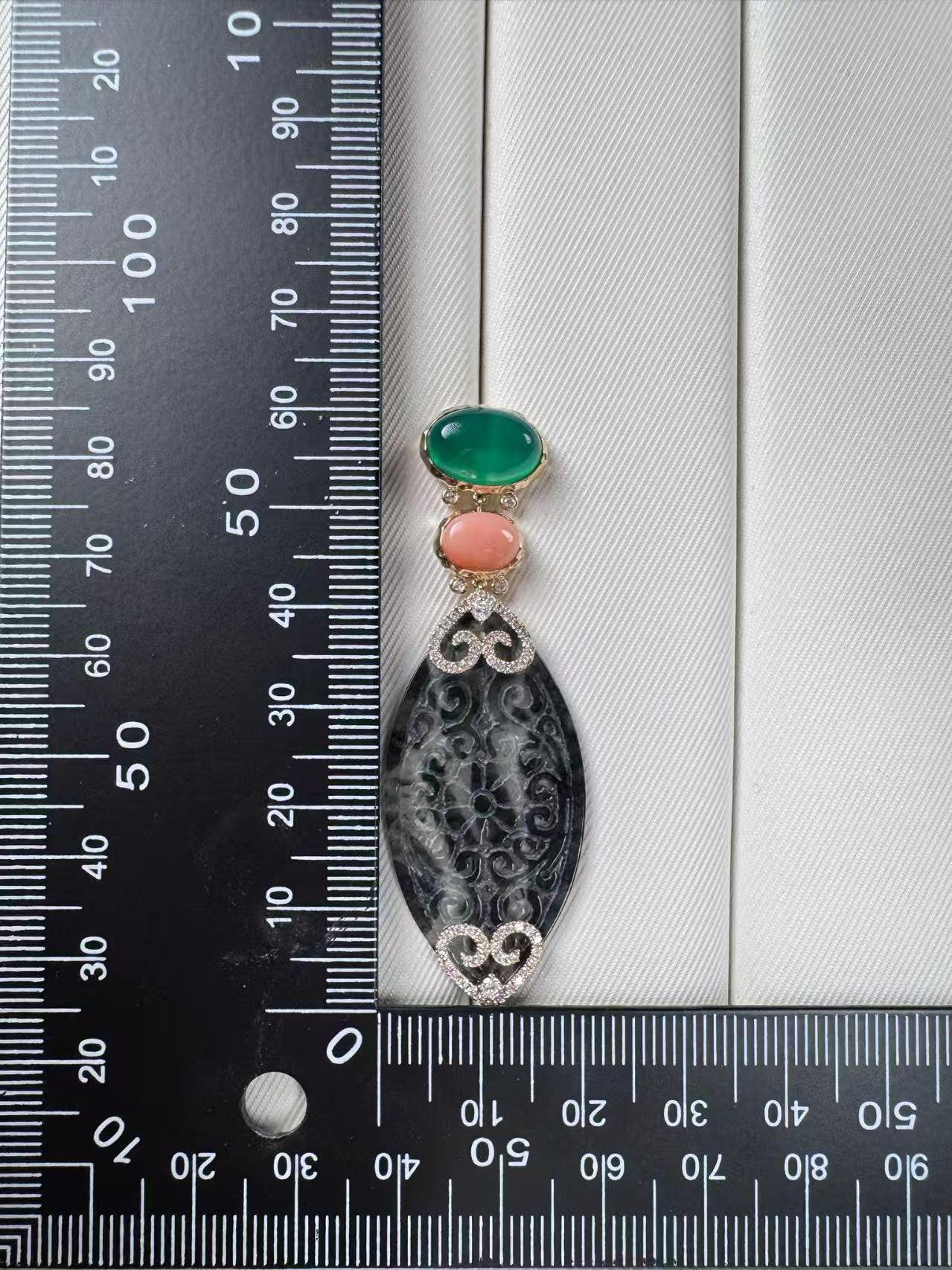 A bold expression of artistry and elegance, these earrings are crafted in 14 karat yellow gold and feature a striking trio of gemstones.   At the top sits a smooth cabochon of vivid green agate (6.49 ct), paired with a warm coral accent (2.57 ct)