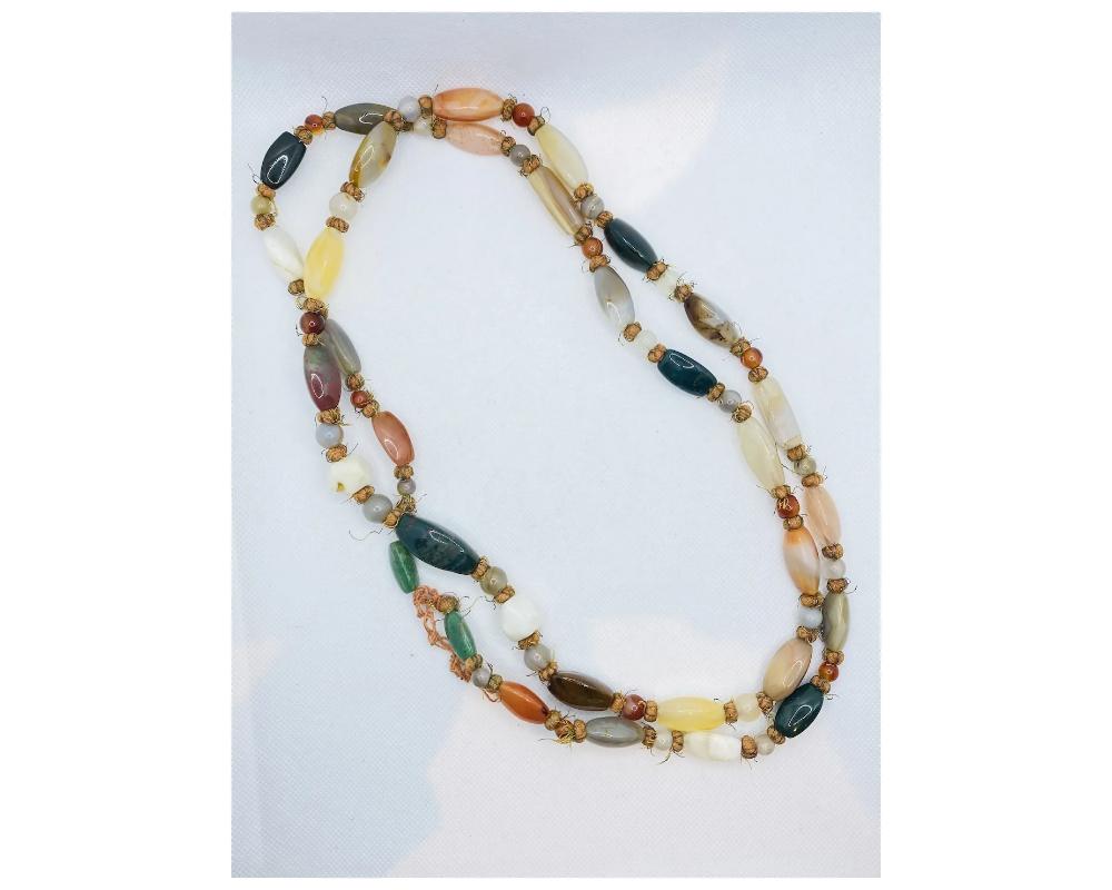 Vintage Agate, Jasper, and Bloodstone Elongated Beaded Necklace 
With sixty-five elongated and spherical agate, jasper and heliotrope beads Bloodstone 
Large and long size is approximately 50 inches long from end to end 
CONDITION minor wear and use