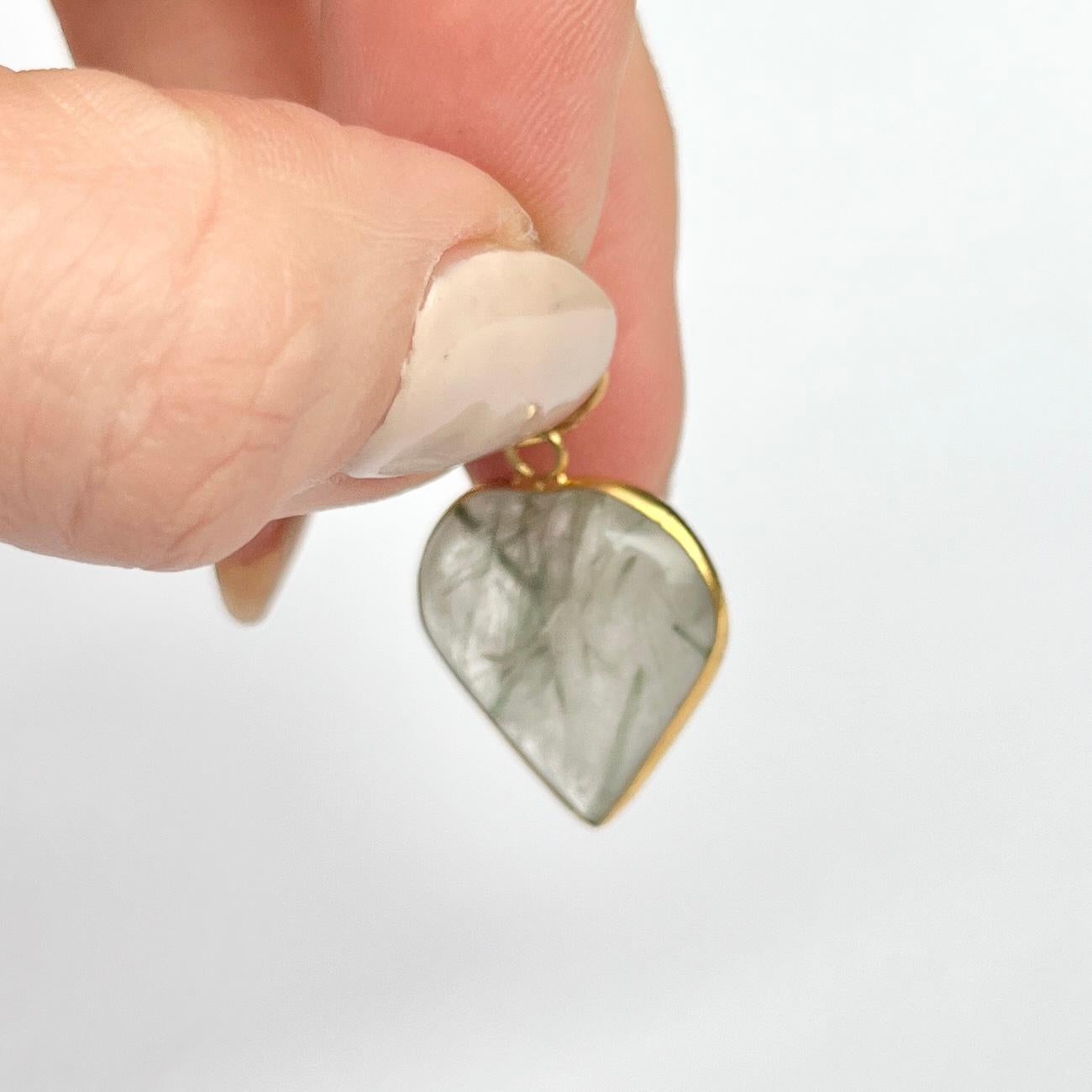 Gorgeous and simple agate pendant. The stone is a soft heart shape and is surrounded by a delicate strip of 9ct gold. 

Height inc loop: 26mm

Weight: 3.1g

