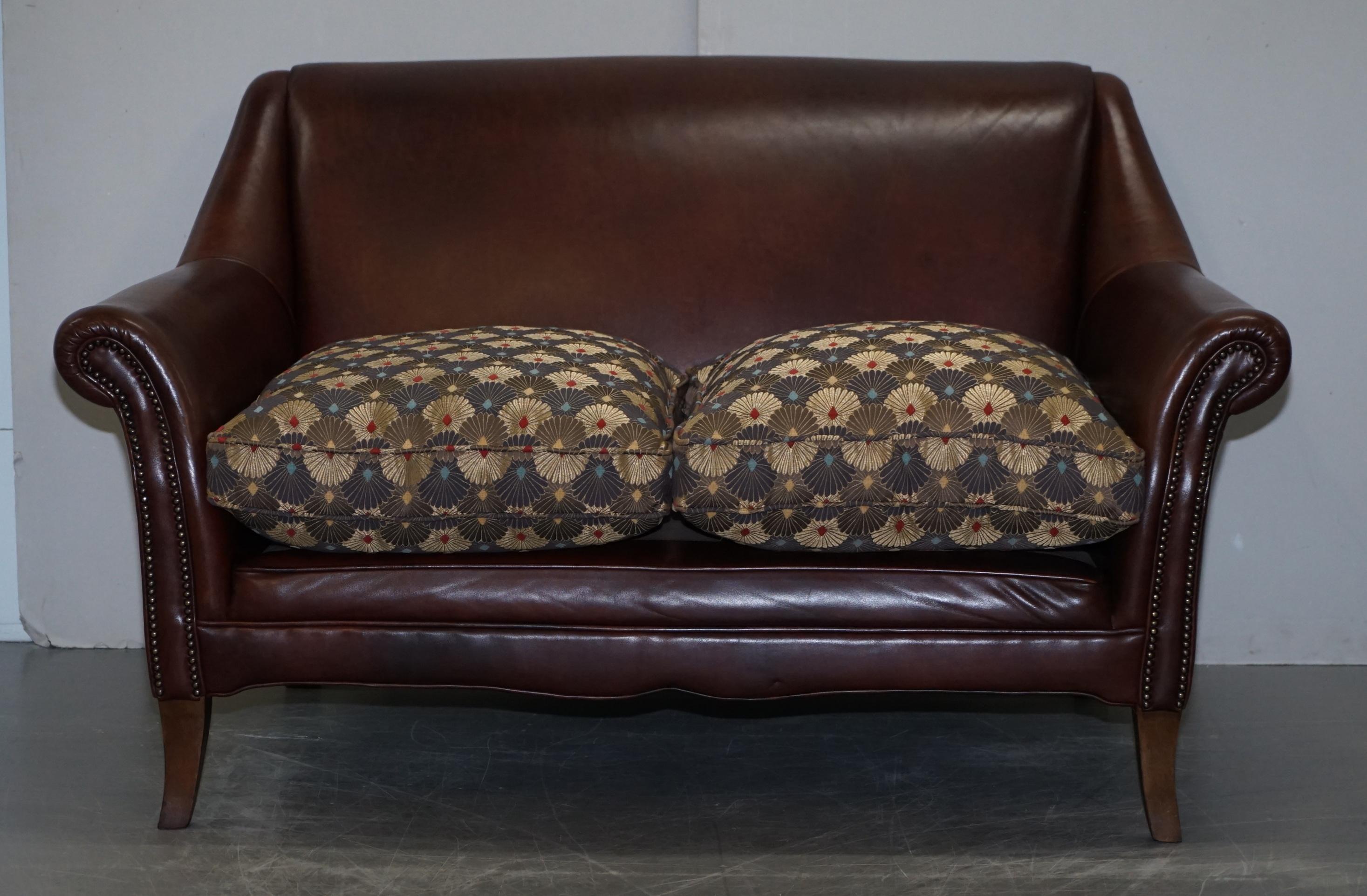 We are delighted to offer for sale this stunning hand made in England brown leather sofa with Liberty’s of London Peacock upholstery cushions

A very good looking comfortable and well made sofa. It has a high contemporary back, over stuffed