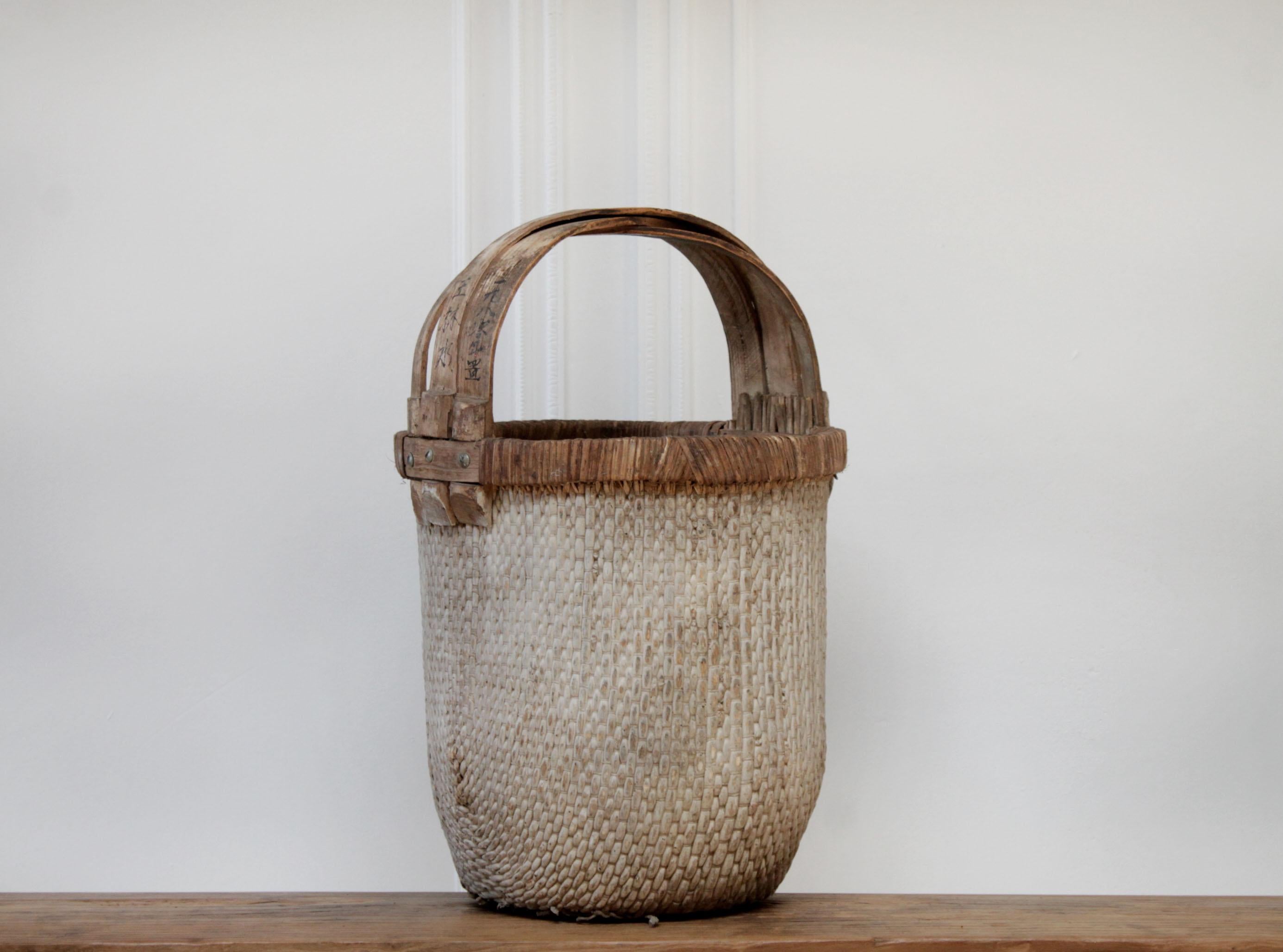 Vintage aged woven Chinese basket
Beautiful light gray exterior, with natural colored handles.
The handles say: 