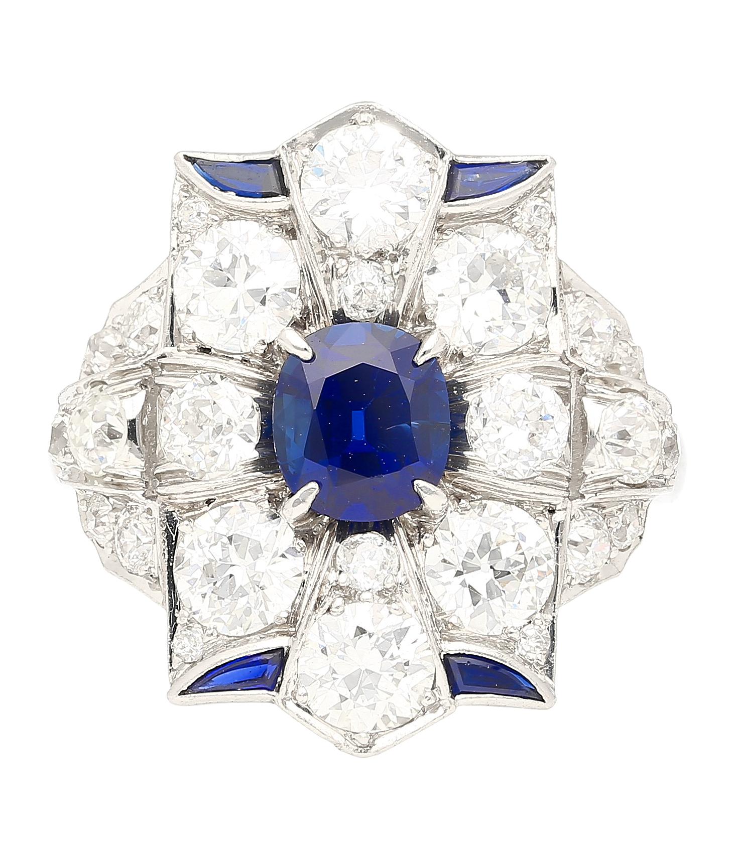 AGL certified 1.27 carat cushion cut no heat blue sapphire and old cut round diamond ring in platinum. This unique, wide frame, multi-stone ring boasts a captivating curved design that gracefully wraps the finger. The piece showcases a striking