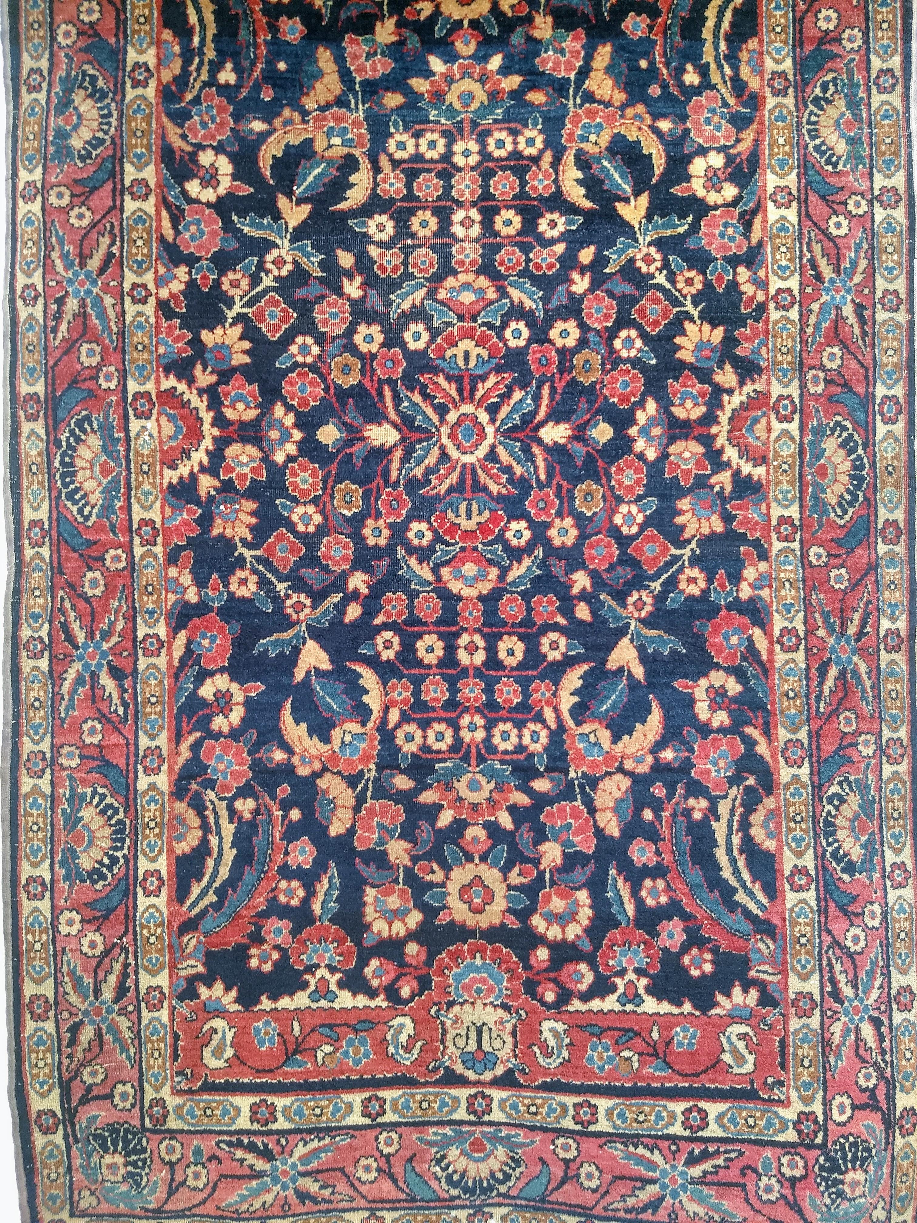  Vintage Agra rug in allover floral pattern in navy Blue and red colors from the early 1900s.   This antique Agra rug has a traditional Mughal design of the rugs that were woven in 16th century India. The field has 