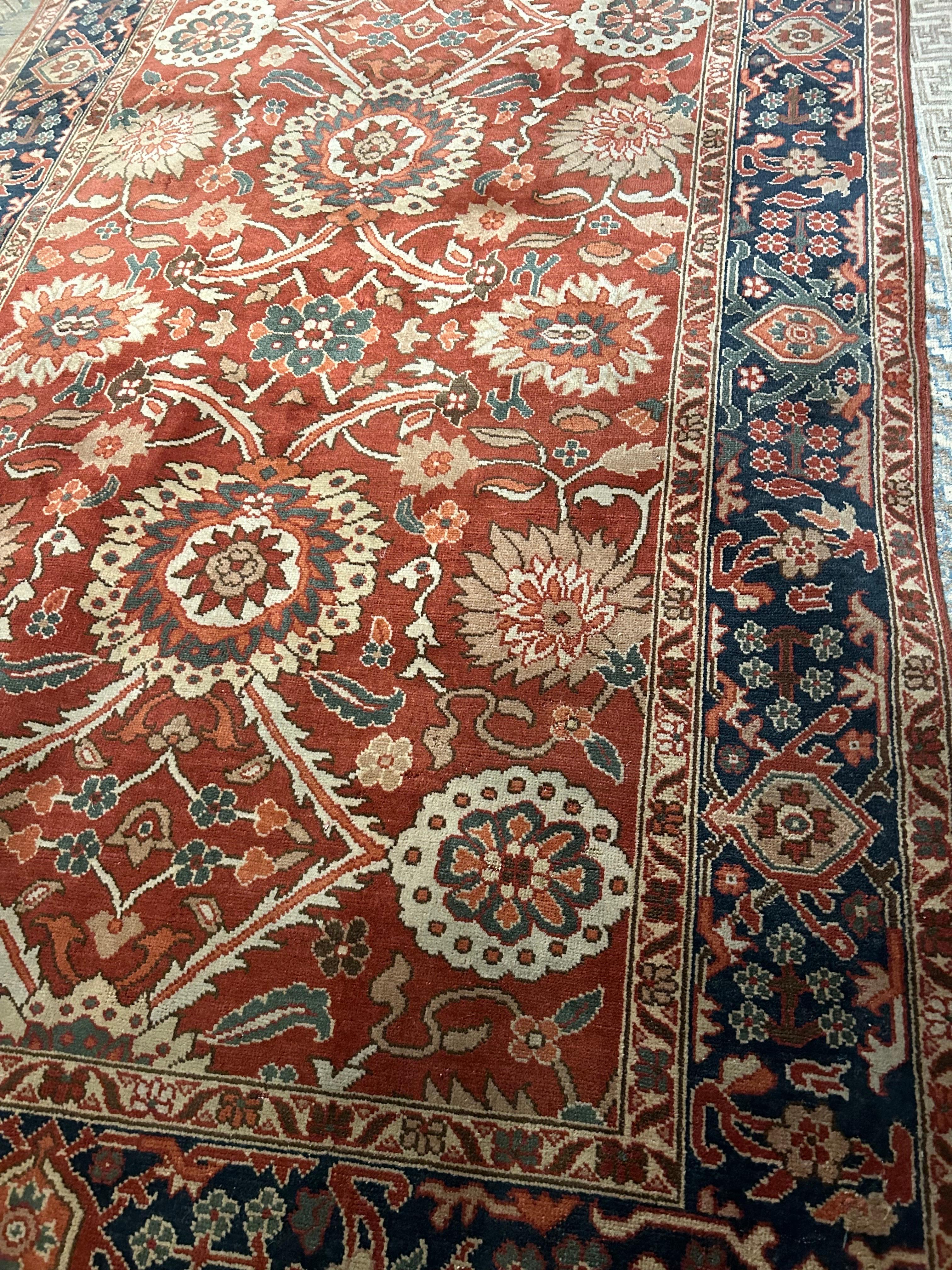 Vintage rug from Agra with floral medallions and a lattice theme. Simple and woven with thicker knots to produce a more rustic overall effect with attention to high durability. Wonderful burnt rust hues and open fields lend to this rug's warm feel.