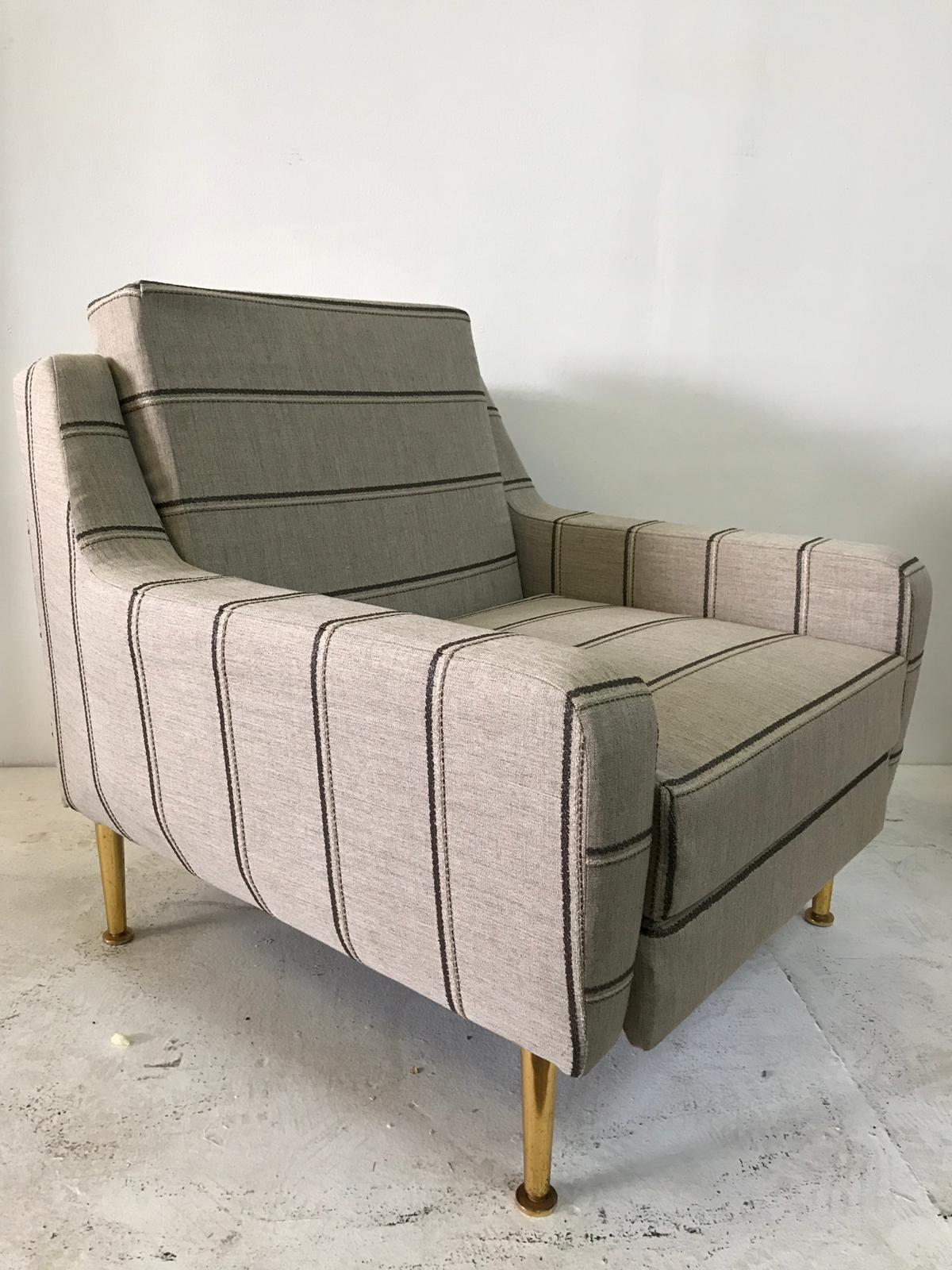 This is a wonderful 1950s Classic Italian designer chair, reupholstered in a natural linen. Original brass feet and headrest. The headrest can be hidden, will make the height of chair 34 inches tall when up.