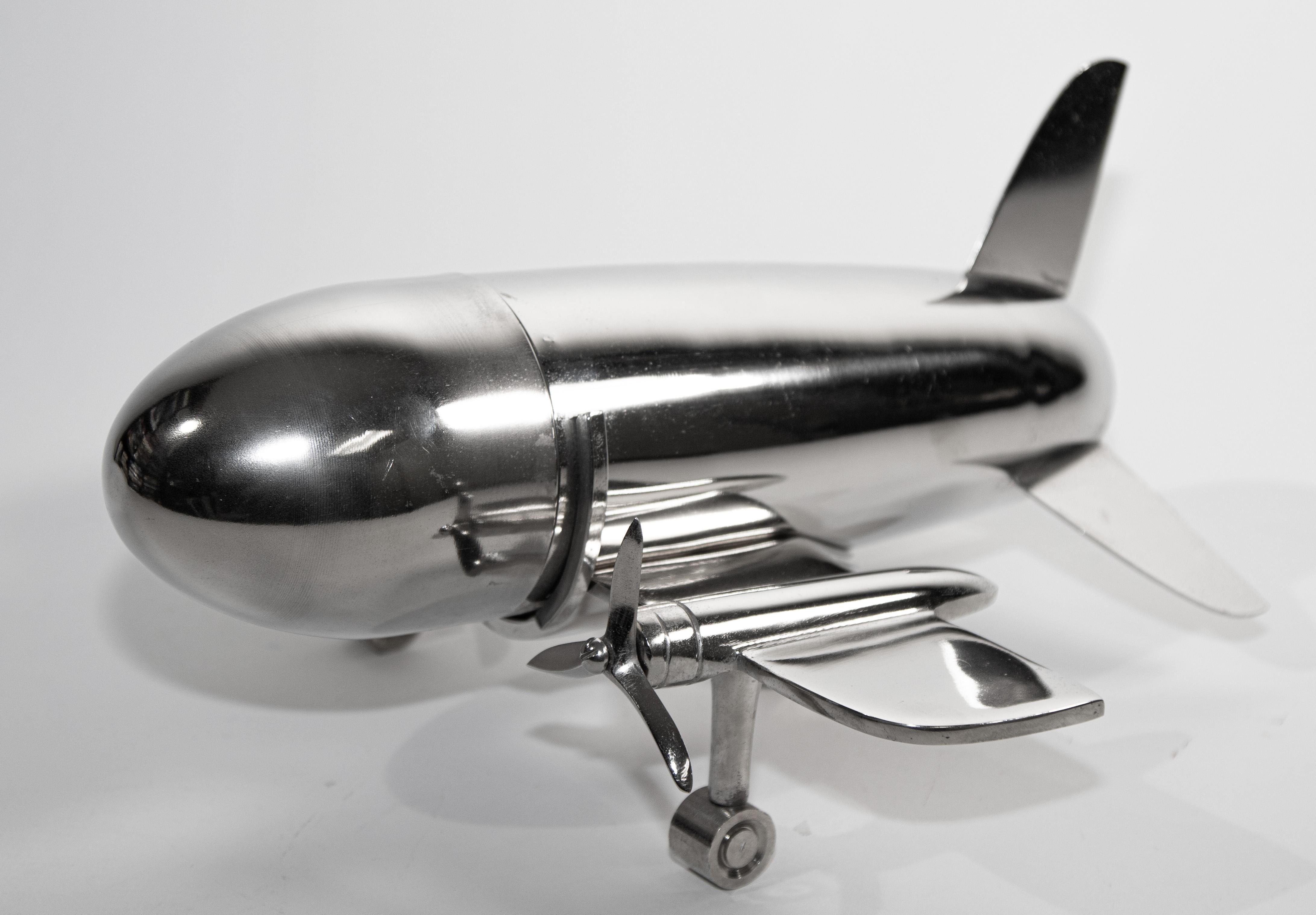 Vintage airplane form cocktail metal shaker.
The airplane is comprised of the body of the airplane that is the cocktail shaker with strainer and cap.
Great aviator cocktail collector. 
Cocktail shaker made of nickel plated metal.
Circa