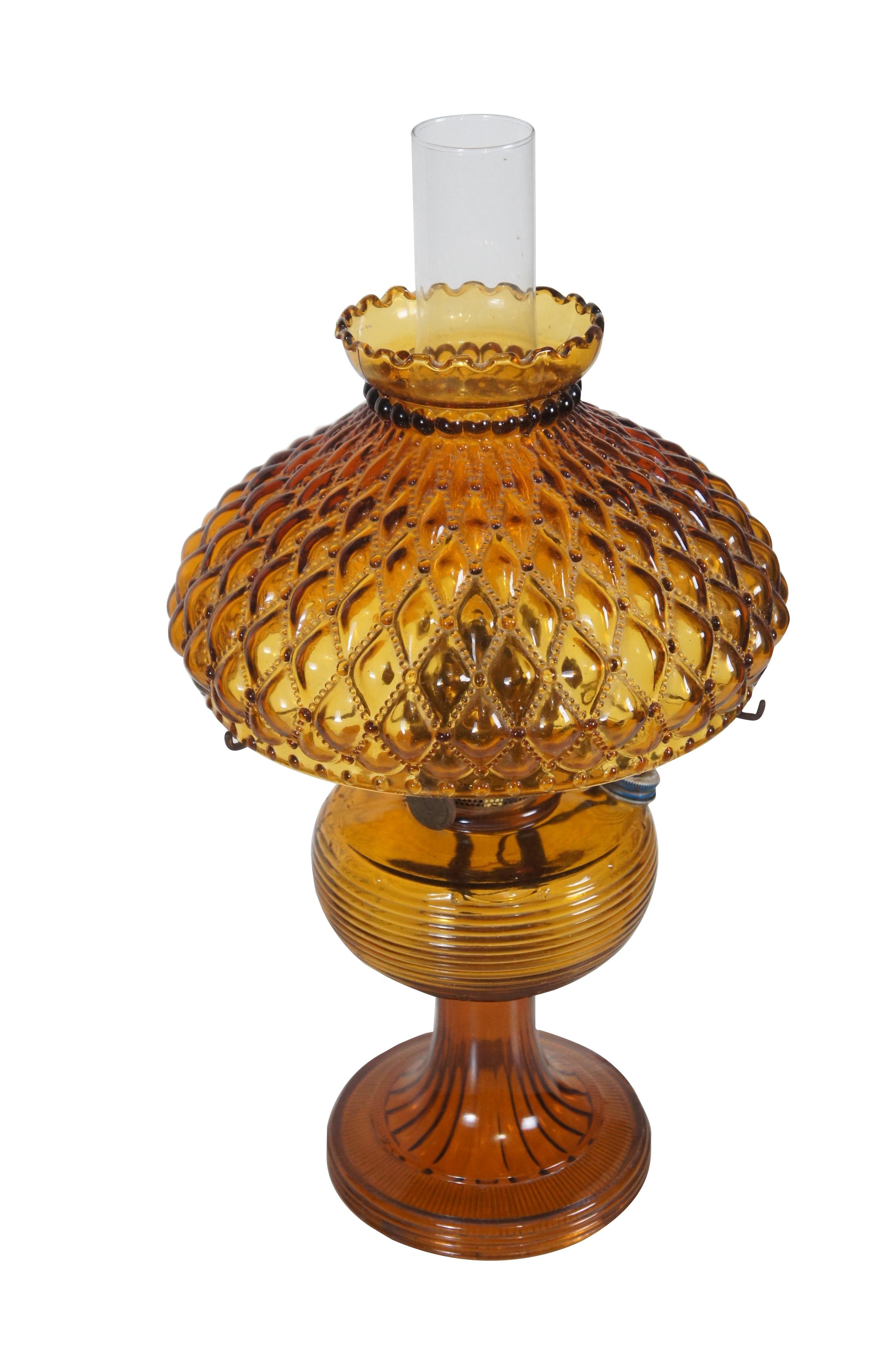Mantle Lamp Company Aladdin Nu Type Model B oil lamp. Grooved amber glass beehive base and quilted / beaded / ruffled edge shade with brass fittings. Includes hurricane. Converted to electric.

Dimensions:
11