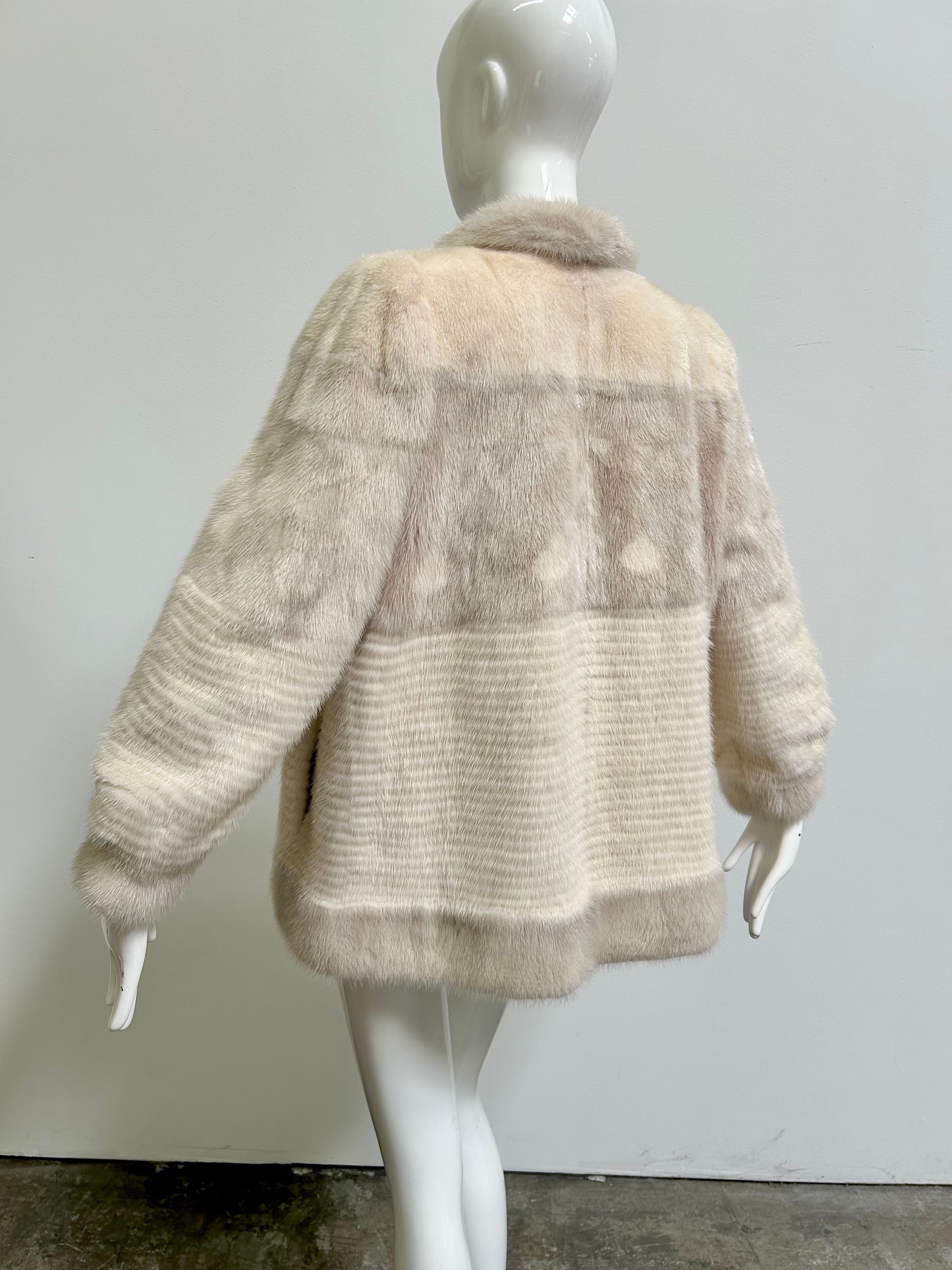 Stunning genuine mink fur jacket, coat with a unique two-tone design. Fully lined with hook closure and monogram on the interior. Side pockets are lined in velvet. Fits like a modern size medium. The bust measures 38
