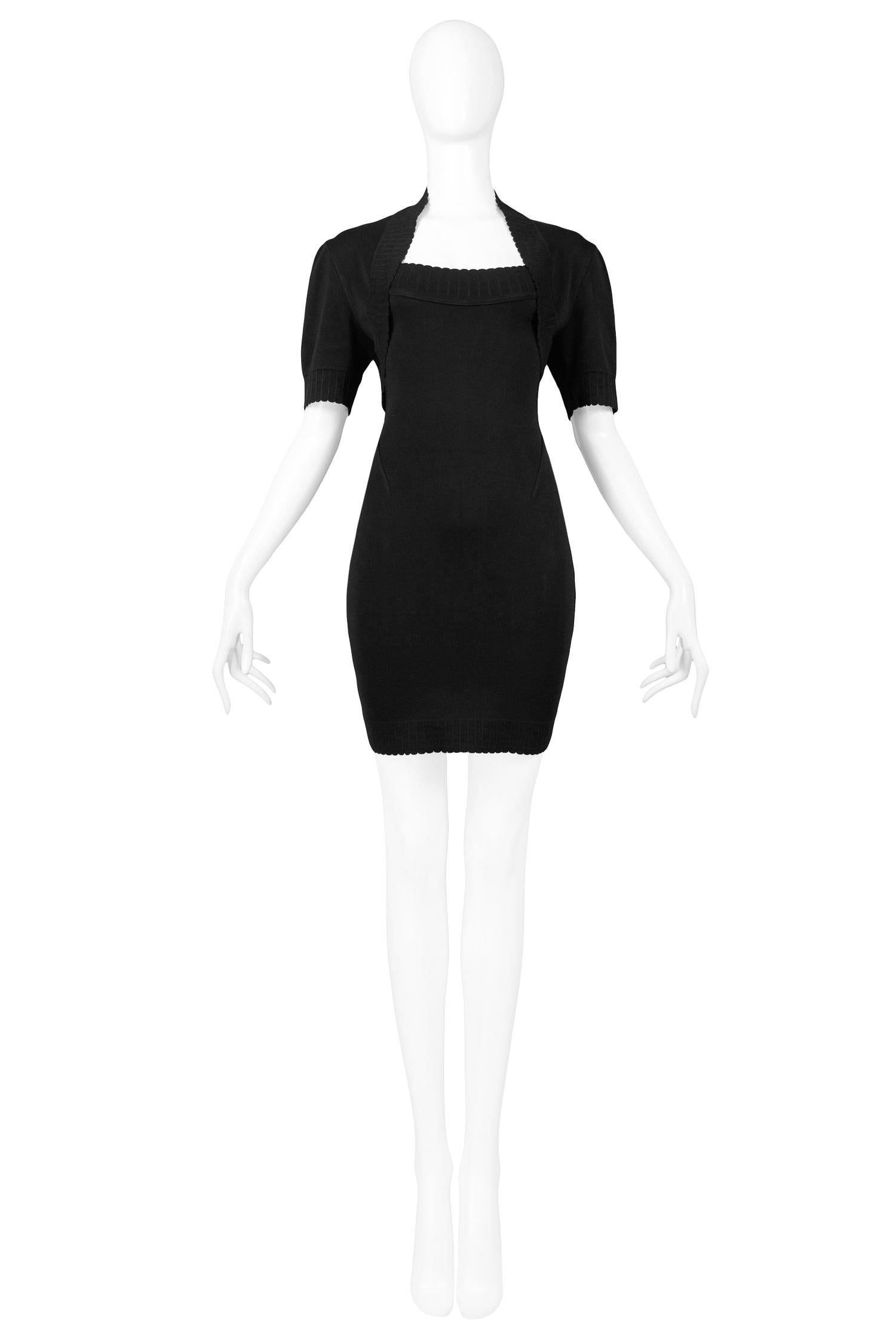 Vintage Azzedine Alaia black stretch cotton knit dress and bolero ensemble. Bolero jacket features elbow length sleeve, crop fit, and open front. The dress features off the shoulder detail, body con fit, and mini length hem. From the 1992