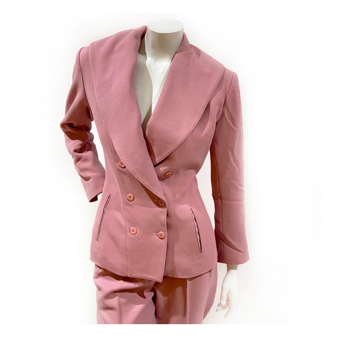Pink Pantsuit by Azzedine Alaia
Made in France
Circa 1990
Double breasted jacket 
High waisted, pleated pant
Dual zip pockets on jacket and pants 
100% Wool (Lining: 57% viscose 43% acetate)
Excellent condition, preloved with no visible wear