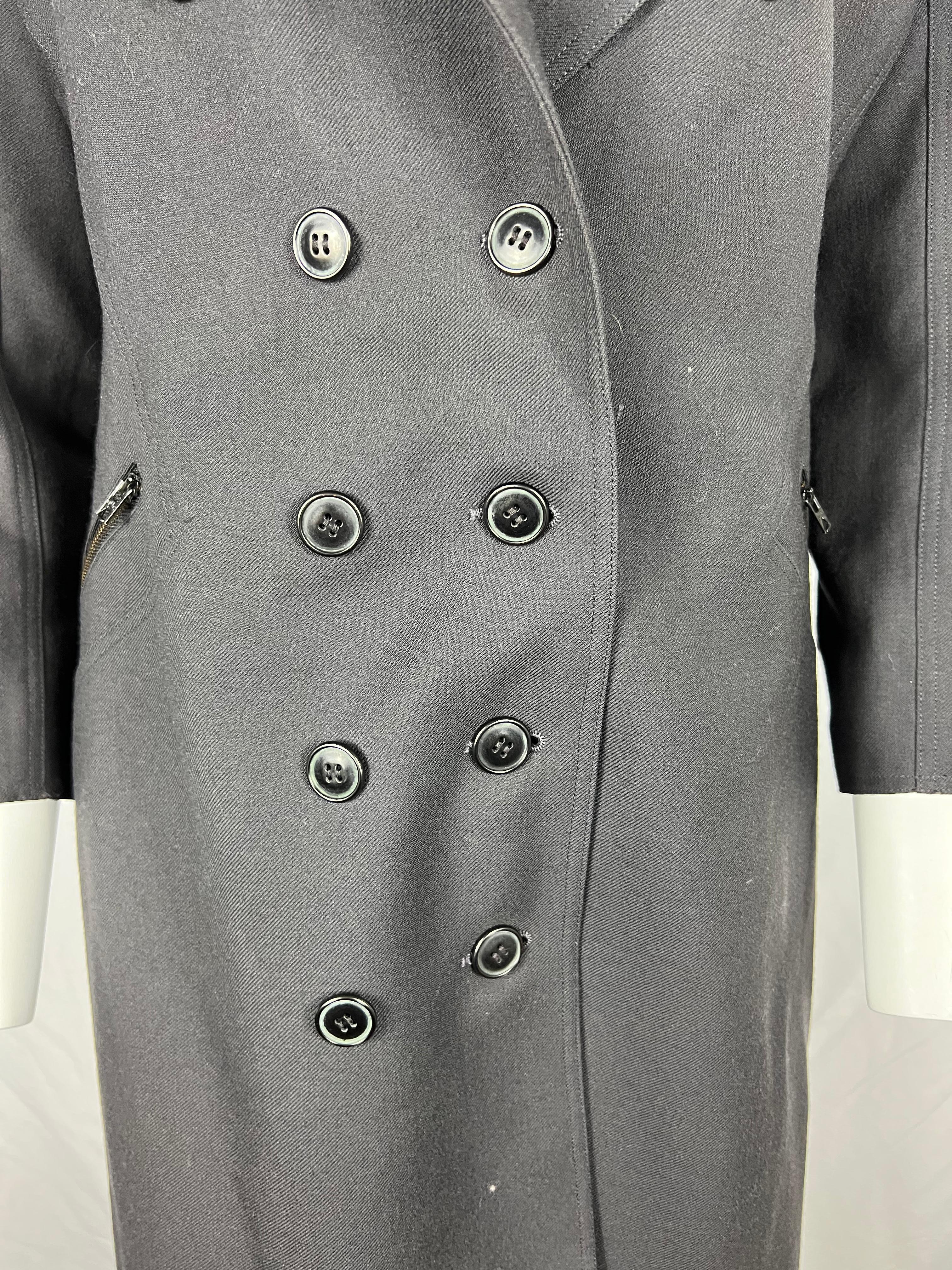 Vintage Alaïa Wool Coat Dark Grey, Size 8
• 3/4 sleeves
• Mid length
• Deep V-neck
• Front button closure
• Ruffled details in the back
• Wide peak collar
• Made in France
 
Item details:
​Each fold and drape of this vintage Alaïa coat was made to
