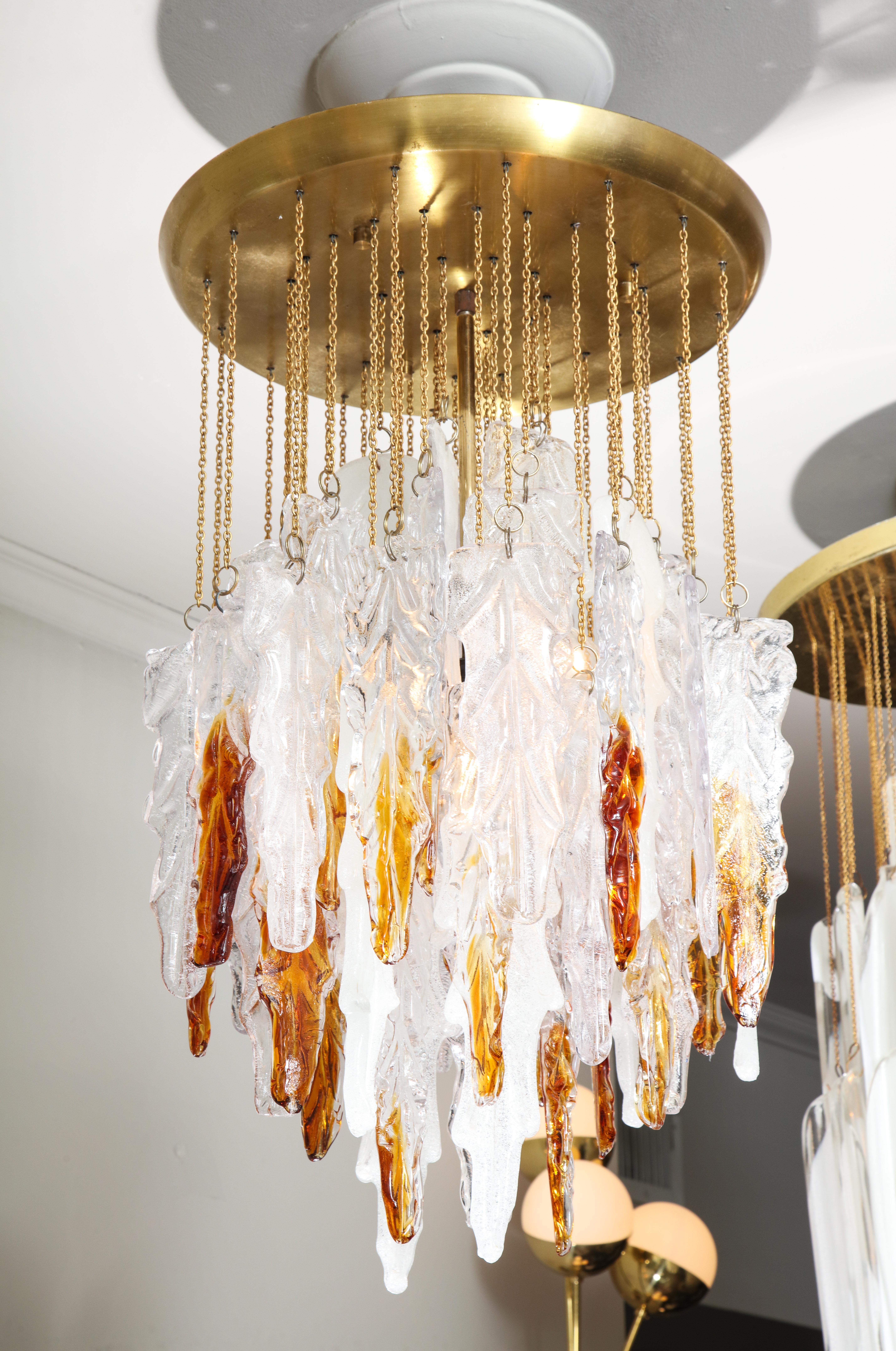 Unusual vintage Poliarte leaf glass chandelier, designed by Alabano Poli in 1970's. The chandelier has a combination of clear, frost and amber colored glass, creating visual variations from every angle. In good condition with minor wear consistent