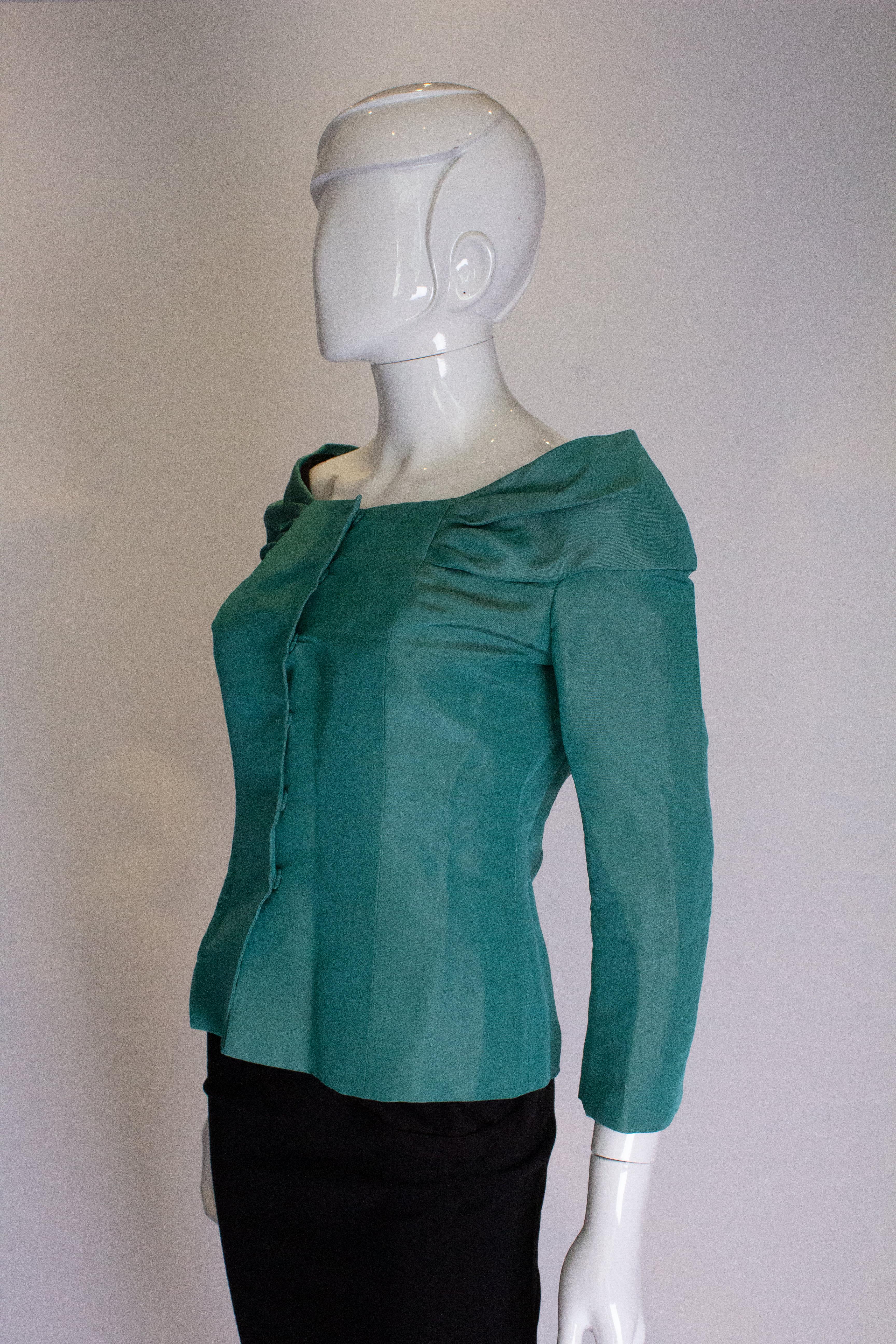 A head turning jacket by Alberta Ferretti. In a pretty sea green colour, the jacket has a shawl collar with bow detail at back and hidden popper fastenings at the front. It is fully  lined.