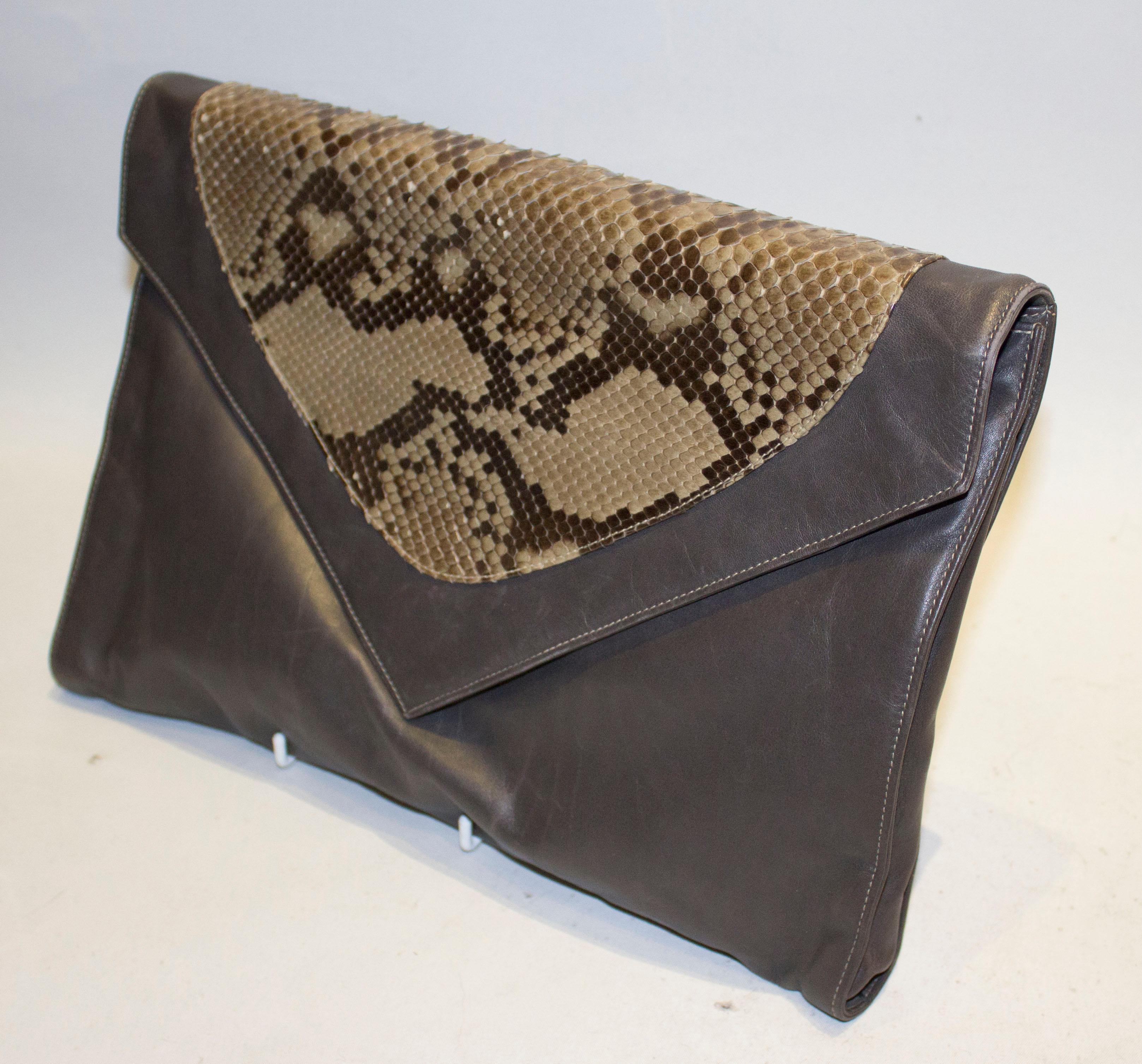 A large vintage super soft leather clutch bag by Aldorvandi. The bag has a flap over front with popper fastening and snakeskin patch. There is an internal zip pocket and strap, so the bag can be used a clutch bag or shoulder bag.
Measurements; Width