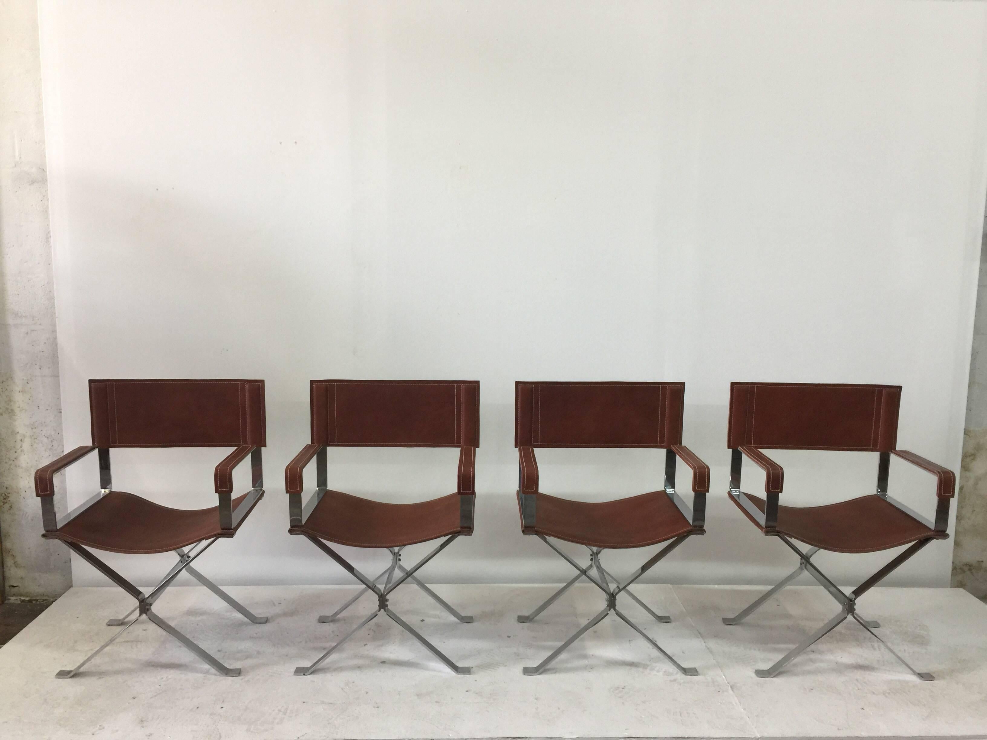 Flat bar steel frame and Cognac stitched leather. These director style armchairs are wonderful vintage Italian design by Alessandro Albrizzi.    
Note: Four quality armchairs!