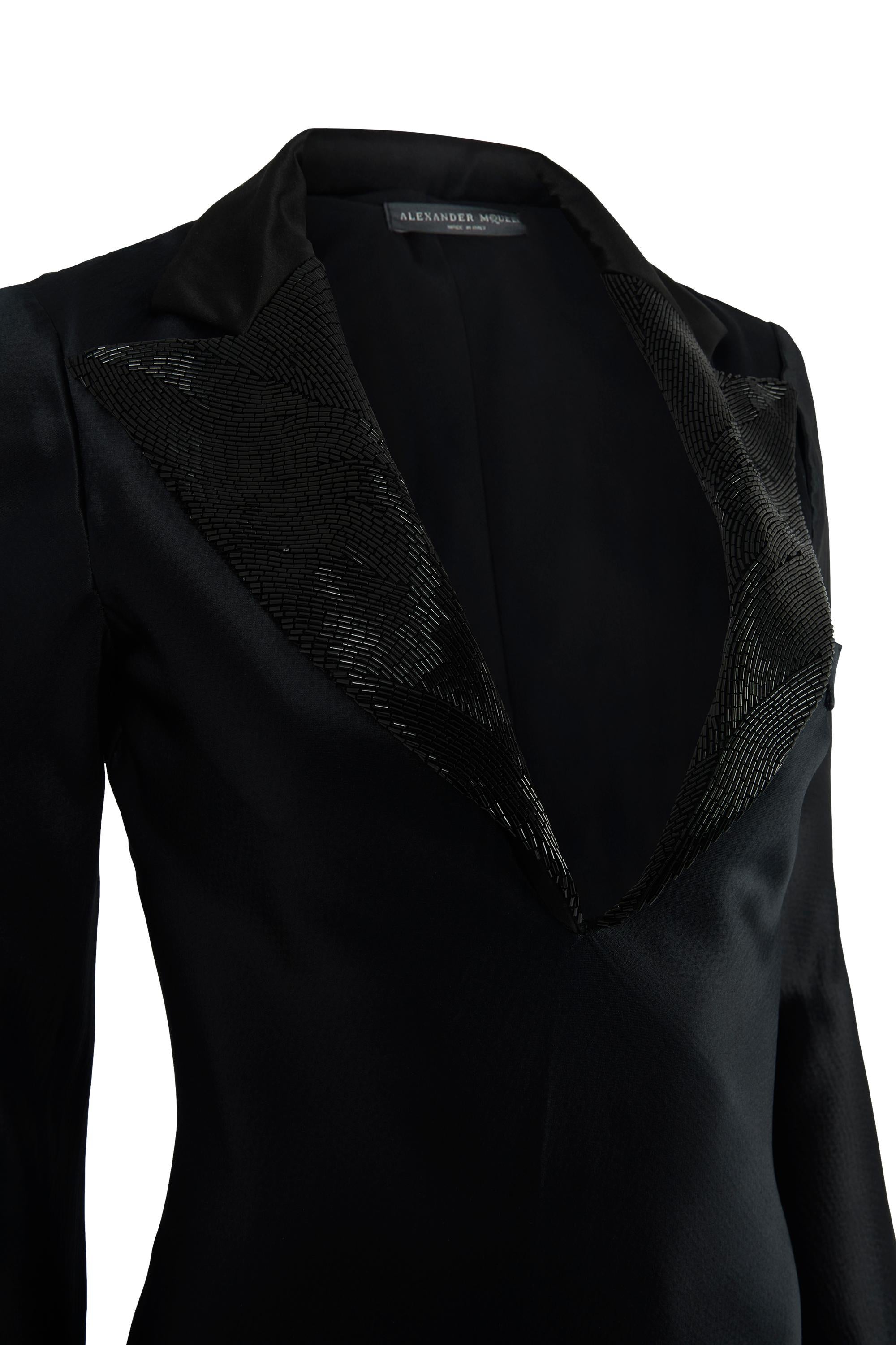 Vintage Alexander McQueen A/W 07 Tuxedo Gown. This gown is from the A/W 2007 collection. The dress features a sheen to the silk with also a black lining. The front of the dress features A deep V-neck which features two beaded black panels as seen on