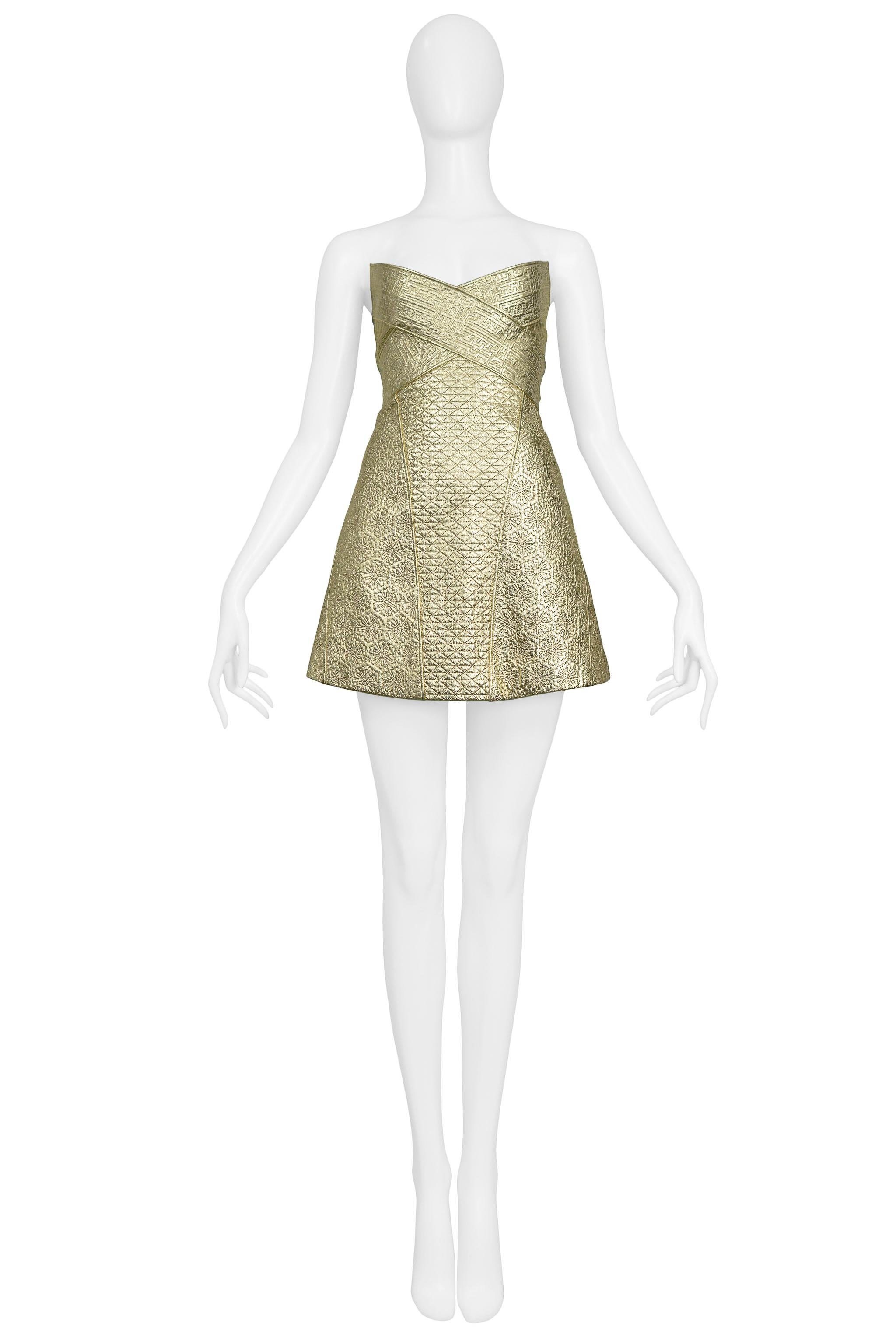 Resurrection is excited to offer a vintage Alexander McQueen gold leather armor dress featuring contrasting quilted and embossed designs, a strapless v front, a-line skirt, and center back zipper. 

Alexander McQueen 
Size 42
100% Leather - 100%