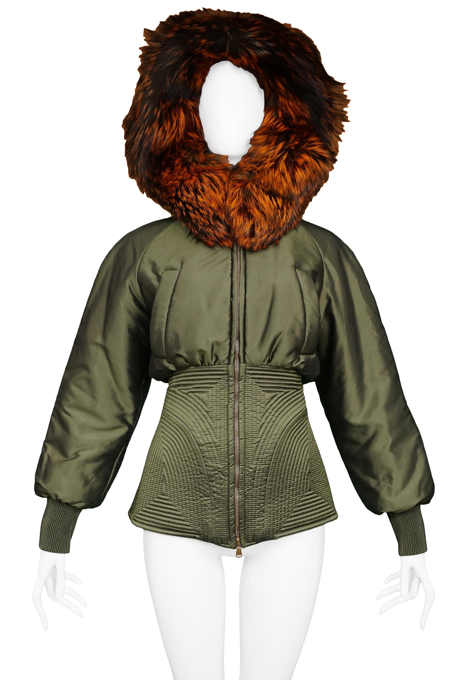 Vintage Alexander McQueen metallic military green corseted parka with auburn fox fur trim. Runway piece from the Autumn/Winter 2007 Collection. 

Excellent Vintage Condition.

Size 38

Measurements:
Bust 38