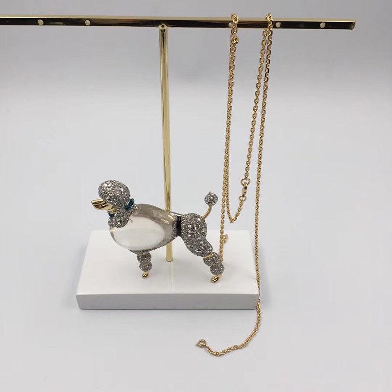 Alexis Bittar Lucite and Faux Diamond Strolling Poodle Dog Jelly Belly Pendant Necklace encrusted with Swarovski Crystals; signed on reverse of Poodle: ALEXIS BITTAR. Golden and Rhodium-tone mounting; Poodle measures approx.  3’’ tall X 2.25’’