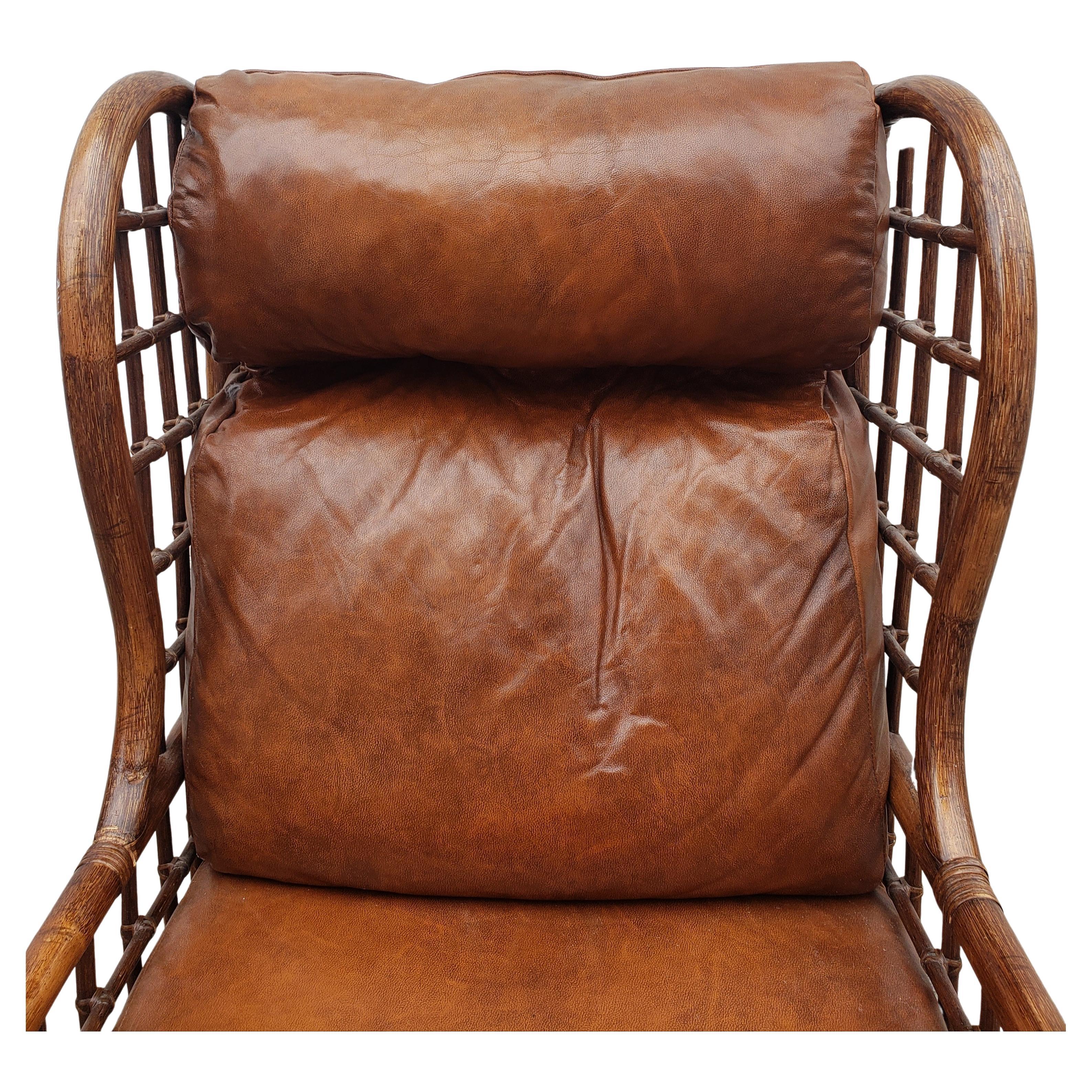 Combining relaxed materials and luxurious comfort, this vintage Alexvale Chair represents unbuttoned island elegance. The webbed rattan and wicker body, bent rattan frame and leather loose leather cushions create a lightweight look from any angle,