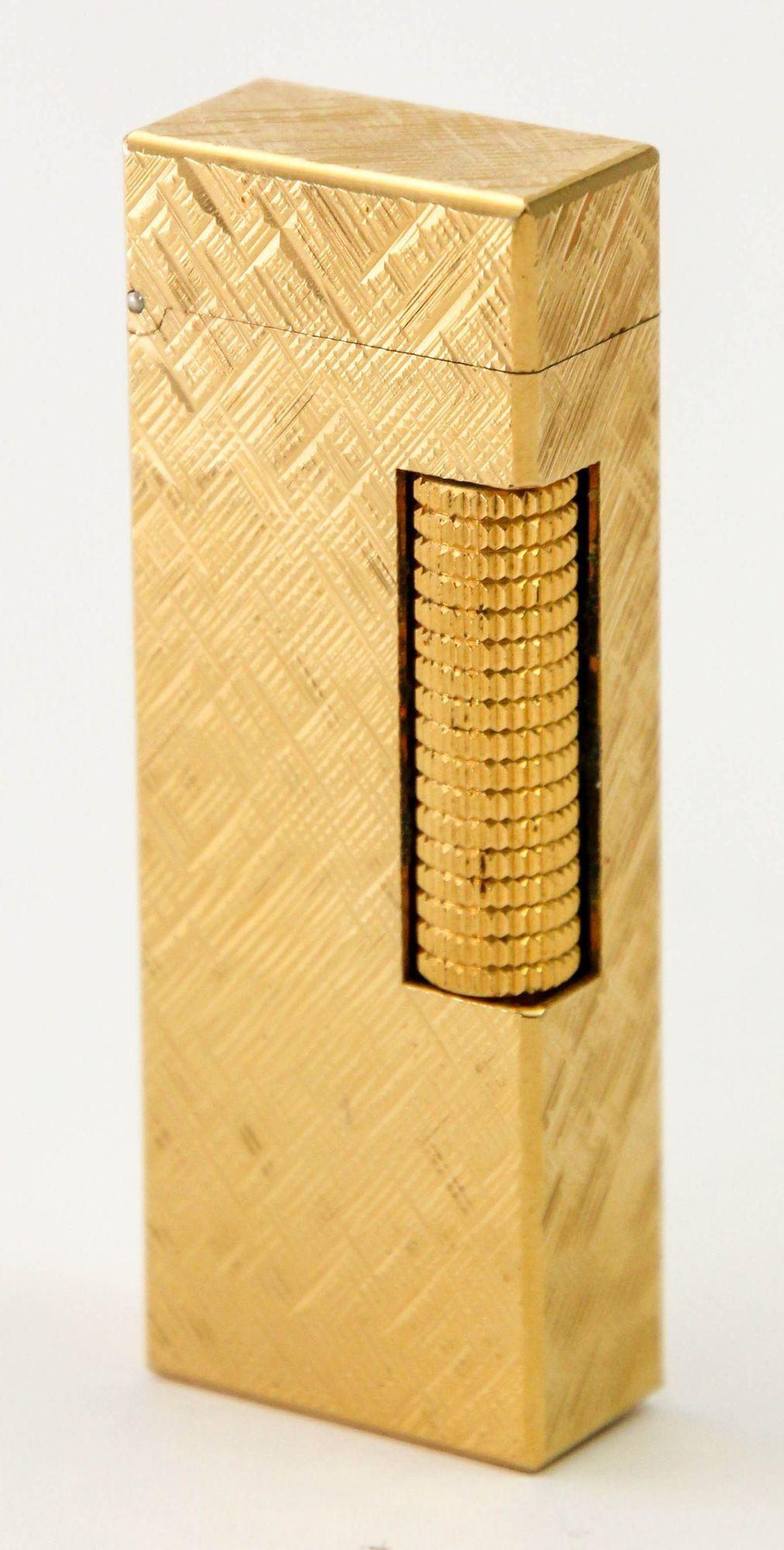 Rare Vintage Iconic Alfred Dunhill Gold Plated Lighter made in Switzerland.This beautiful Dunhill Rollagas 24k Gold Plated Florentine Pattern Lighter was crafted in the 1980s. It is a beautiful example of the true vintage Dunhill Rollagas series. It