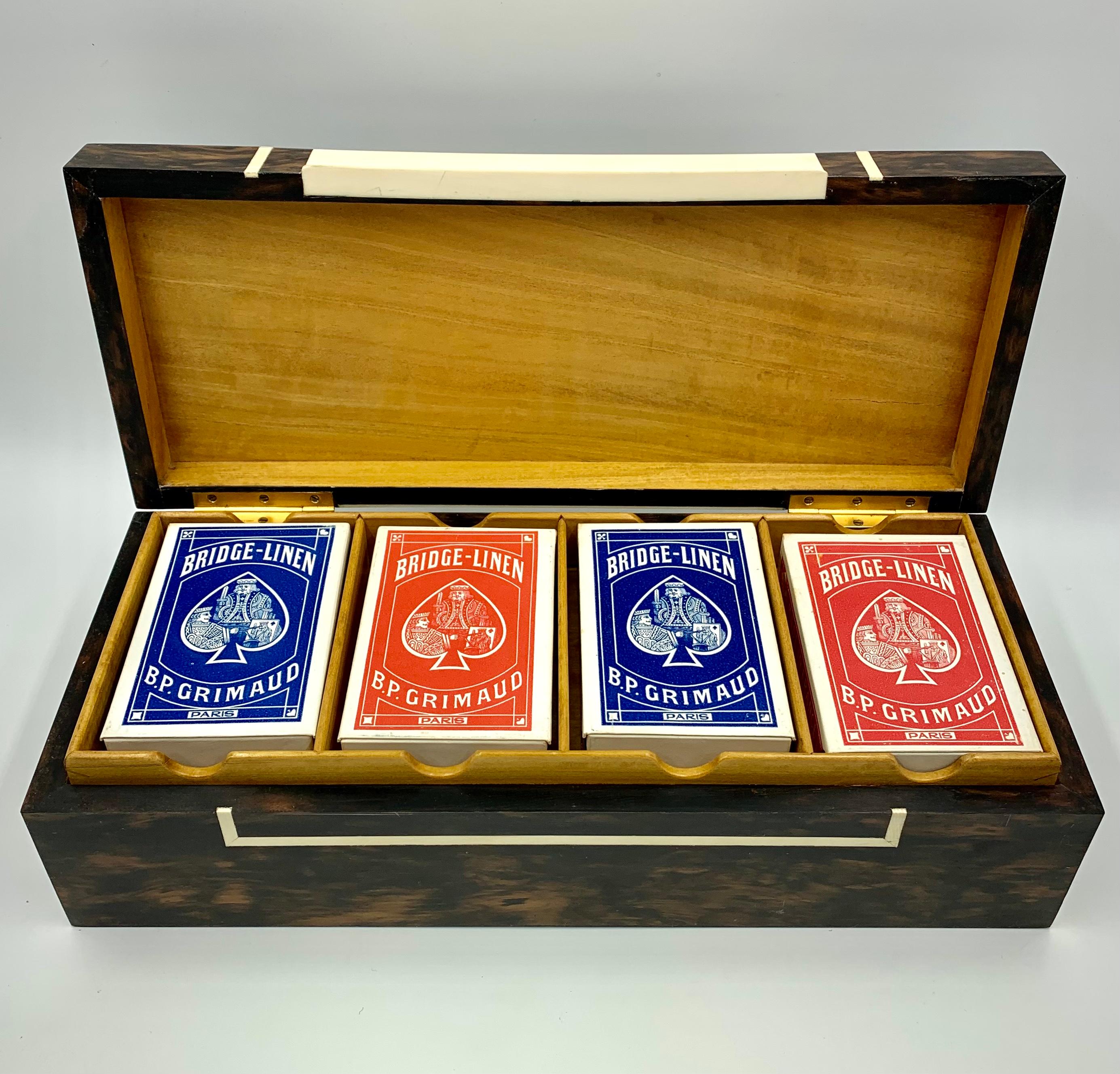 A fabulous vintage gaming box by London's esteemed luxury goods maker Dunhill. Signed Alfred Dunhill Paris fab. Anglaise, this exotic wood game box is fitted with a removable tray for four decks of cards with a bottom compartment for scoring