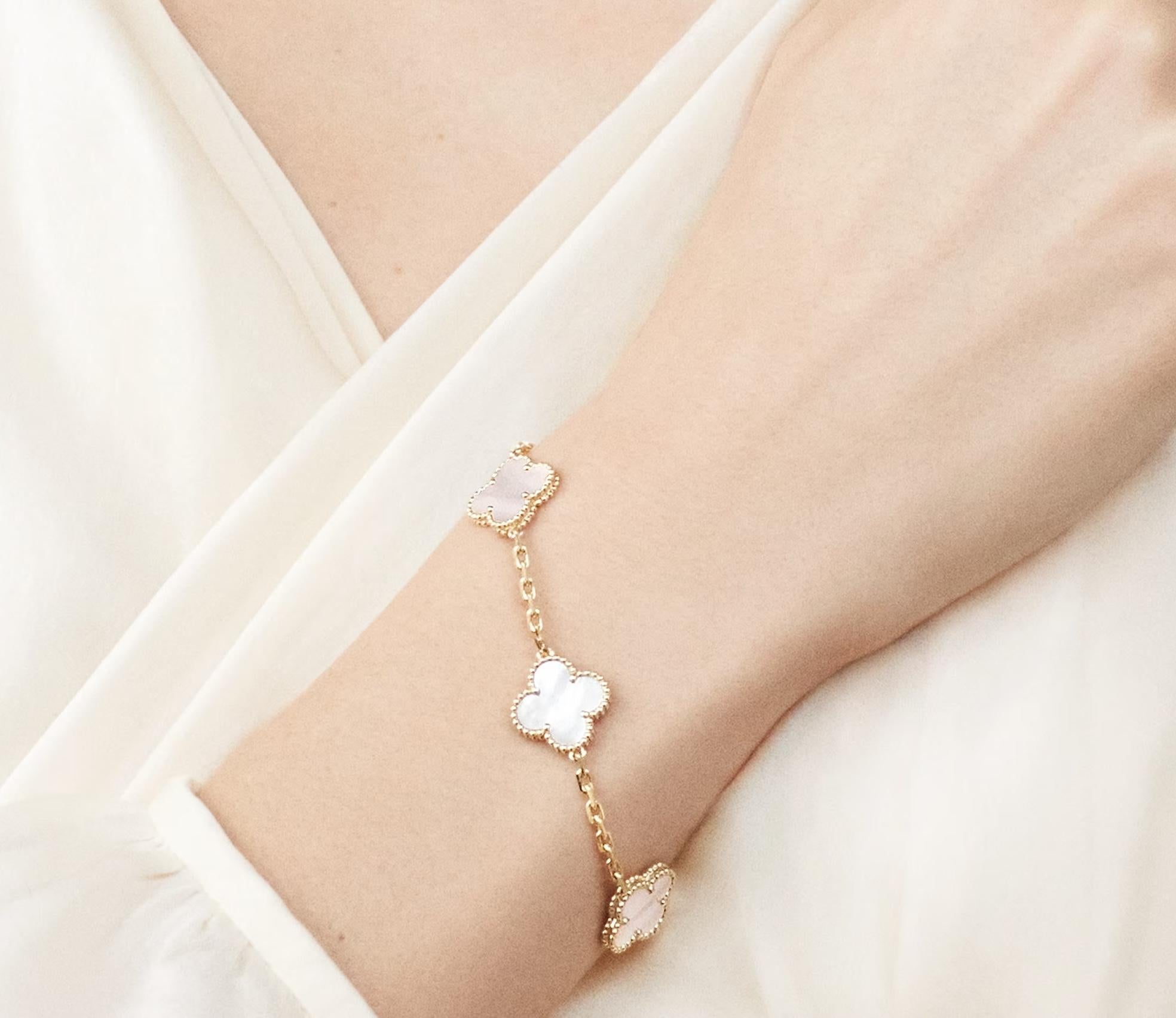 The Van Cleef & Arpels Vintage Alhambra bracelet is a timeless piece that showcases elegance and fine craftsmanship. 
This Authentic VCA Alhambra bracelet is crafted in 18K yellow gold and features five mother-of-pearl clover motifs, each surrounded