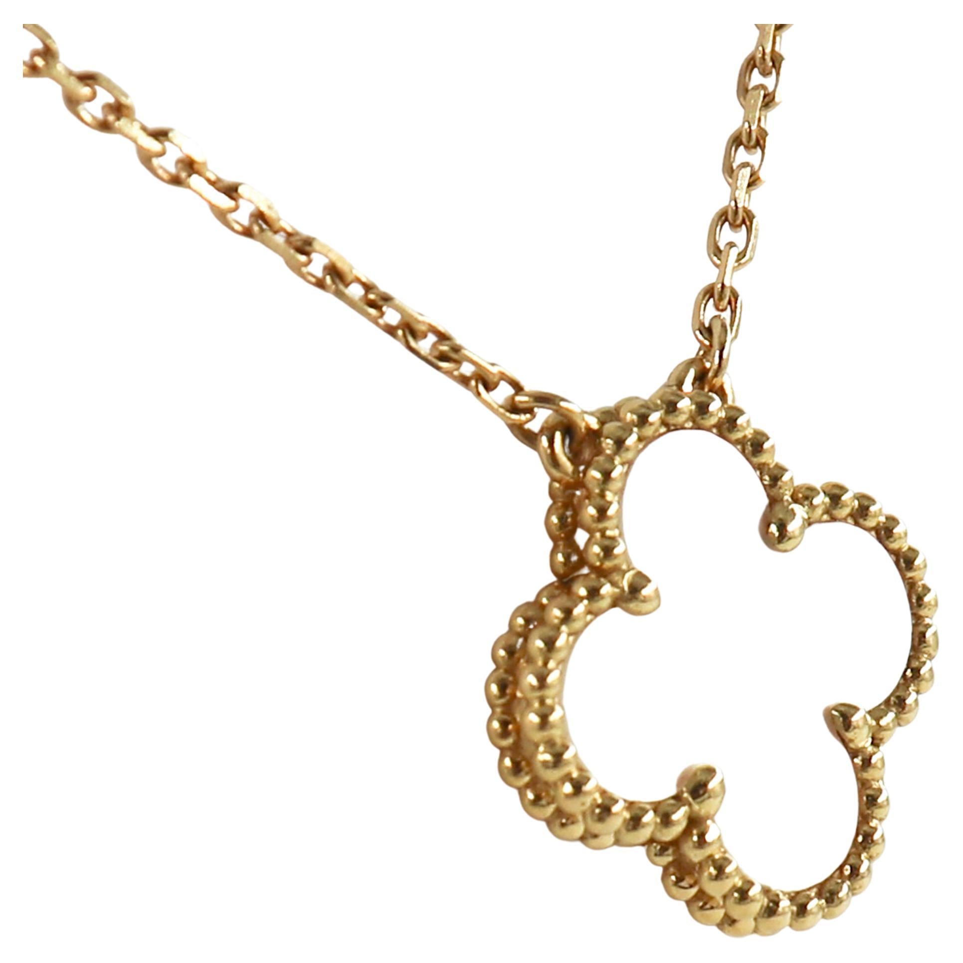 This Van Cleef & Arpels 18K Yellow Gold Necklace features a cloverleaf crafted in Mother-of-pearl adorned with a border of golden beads. 

This chain length measures 17 inches and is stamped 'VCA', '750', and with the serial number. 

Type: Pendant