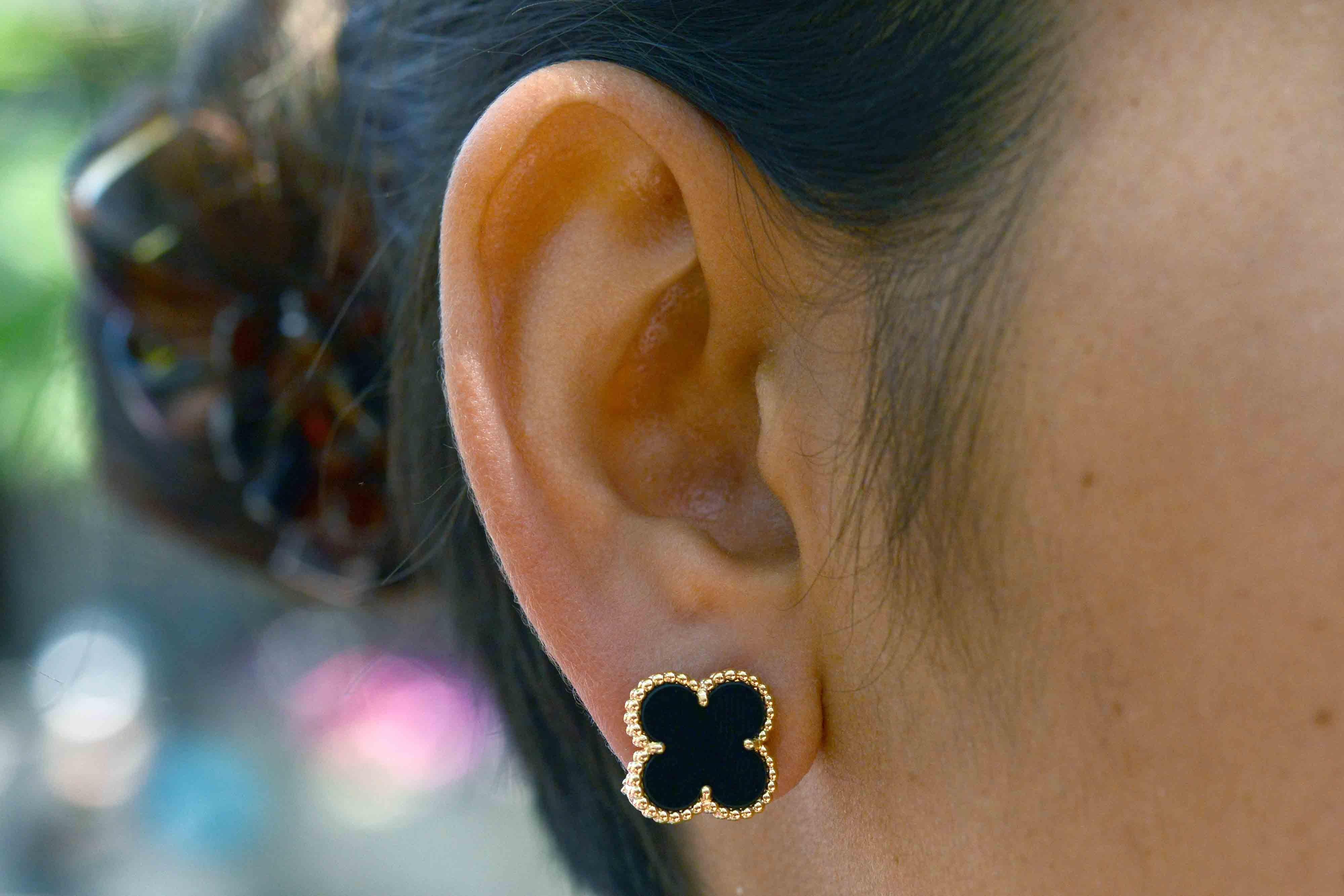 Glowing in yellow gold and black onyx, these Vintage Alhambra earrings by Van Cleef & Arpels are distinguished by their unique, timeless elegance. Inspired by the clover leaf, these icons of luck are adorned with a border of golden beads.Purchased