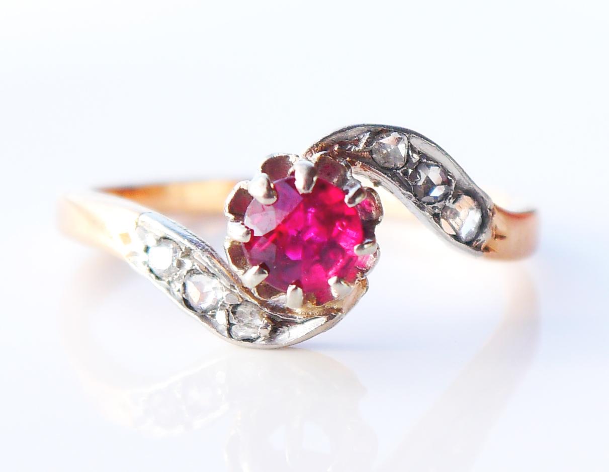 Beautiful Gold, Ruby + Diamonds Ring, made circa 1900 -1920s.

Solid 18ct rose Gold twisted frame, claw set diamond cut natural Red Ruby stone Ø 4.75 /0.5 ct with inclusions visual under x 10 magnification.
Ruby is flanked with 6 old mine cut