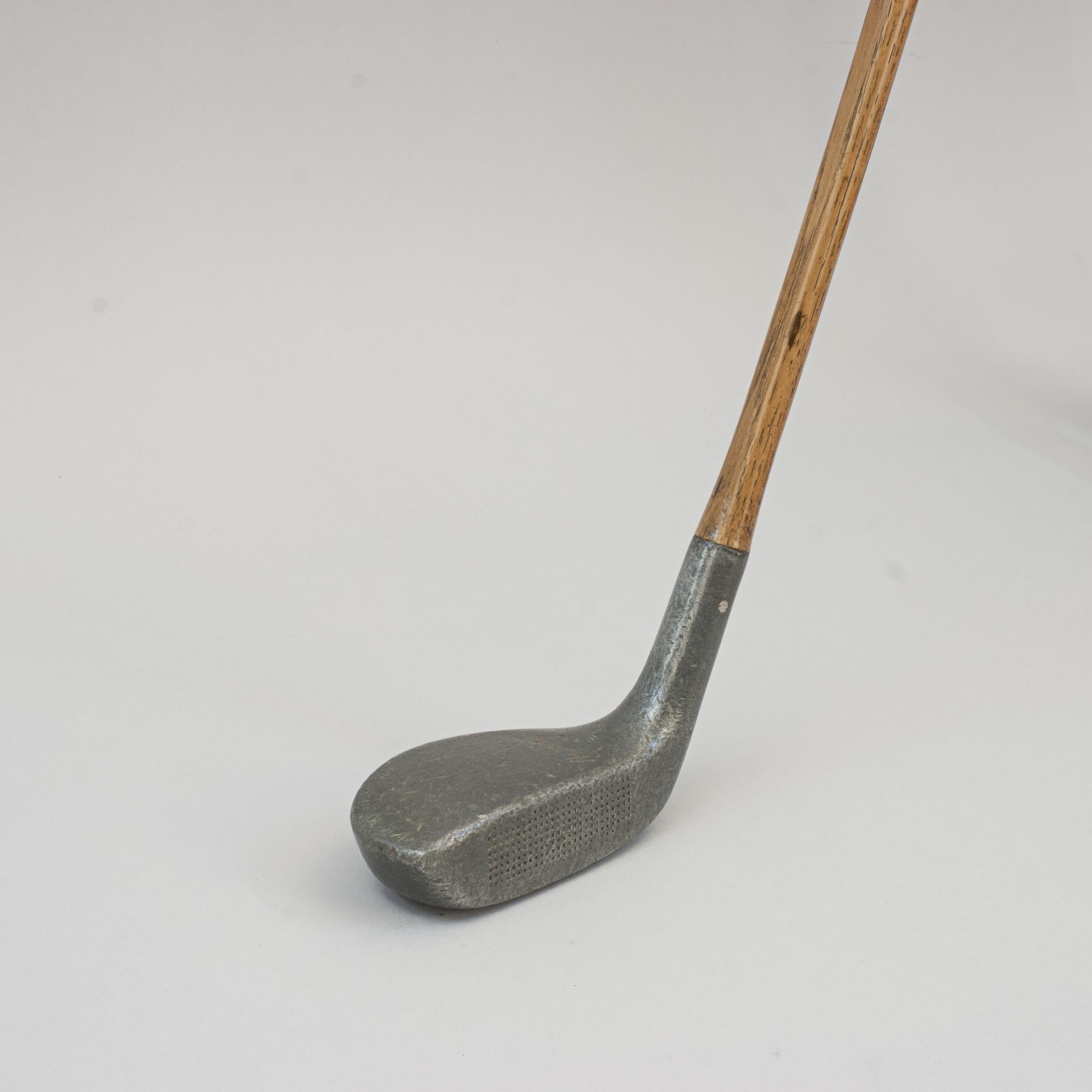 Huntly Aluminium Mallet Head Putter.
A good example of an aluminium head putter fitted with an original hickory shaft with a 'Huntly Grip'. The wooden shaft is round from the hosel terminating into a thicker rectangular handle. The back of the