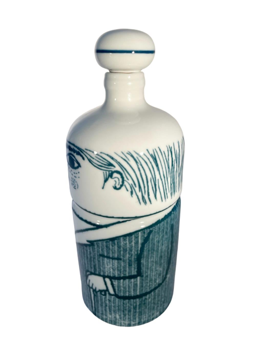 Porcelain decanter or bar bottle of cylindrical form with domed top having a ball-form porcelain and cork stopper. Decorated in underglaze blue as a gentleman wearing a suit and tie and holding a pocket watch in one hand and an umbrella or walking