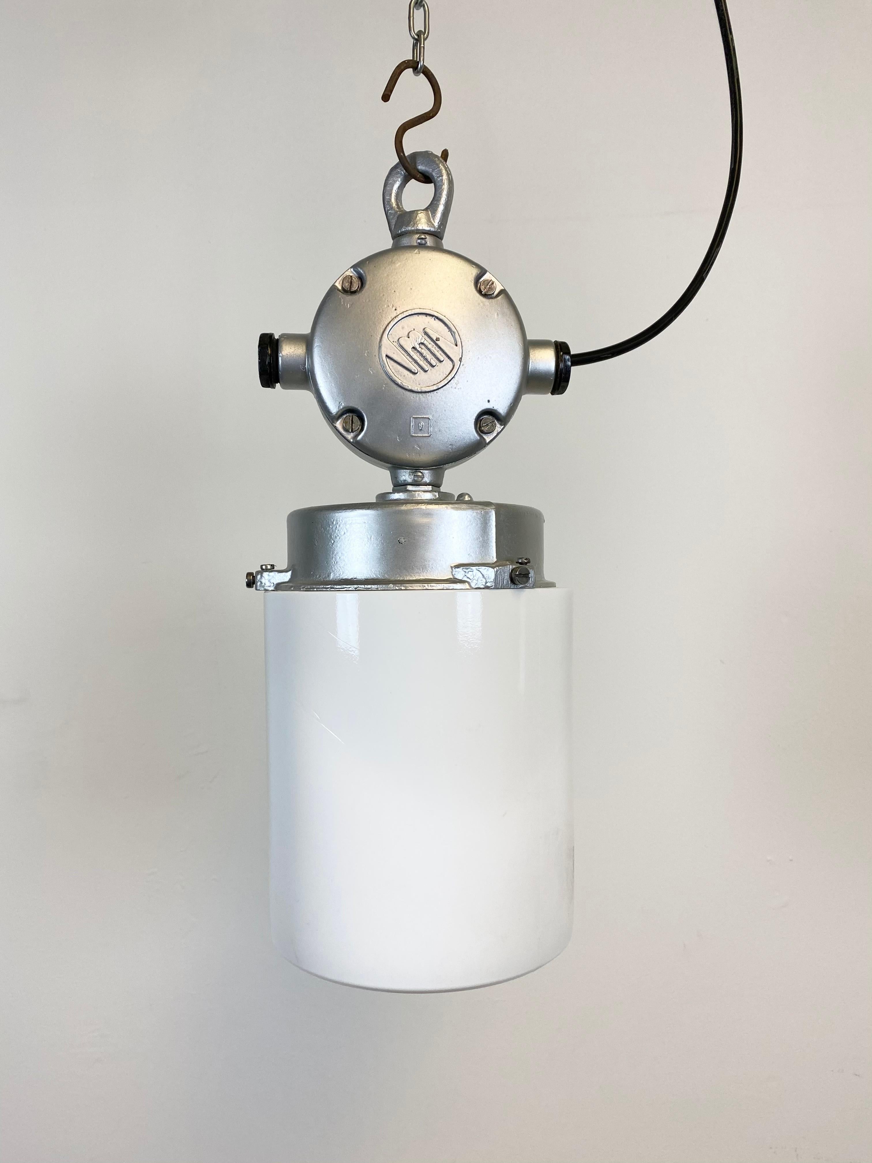 This industrial lamp in aluminium with milk glass was produced during the 1970s in former Czechoslovakia. It features a cast aluminium top and a milk glass. New porcelain socket for E 27 lightbulbs and wire. The weight of the lamp is 2 kg.