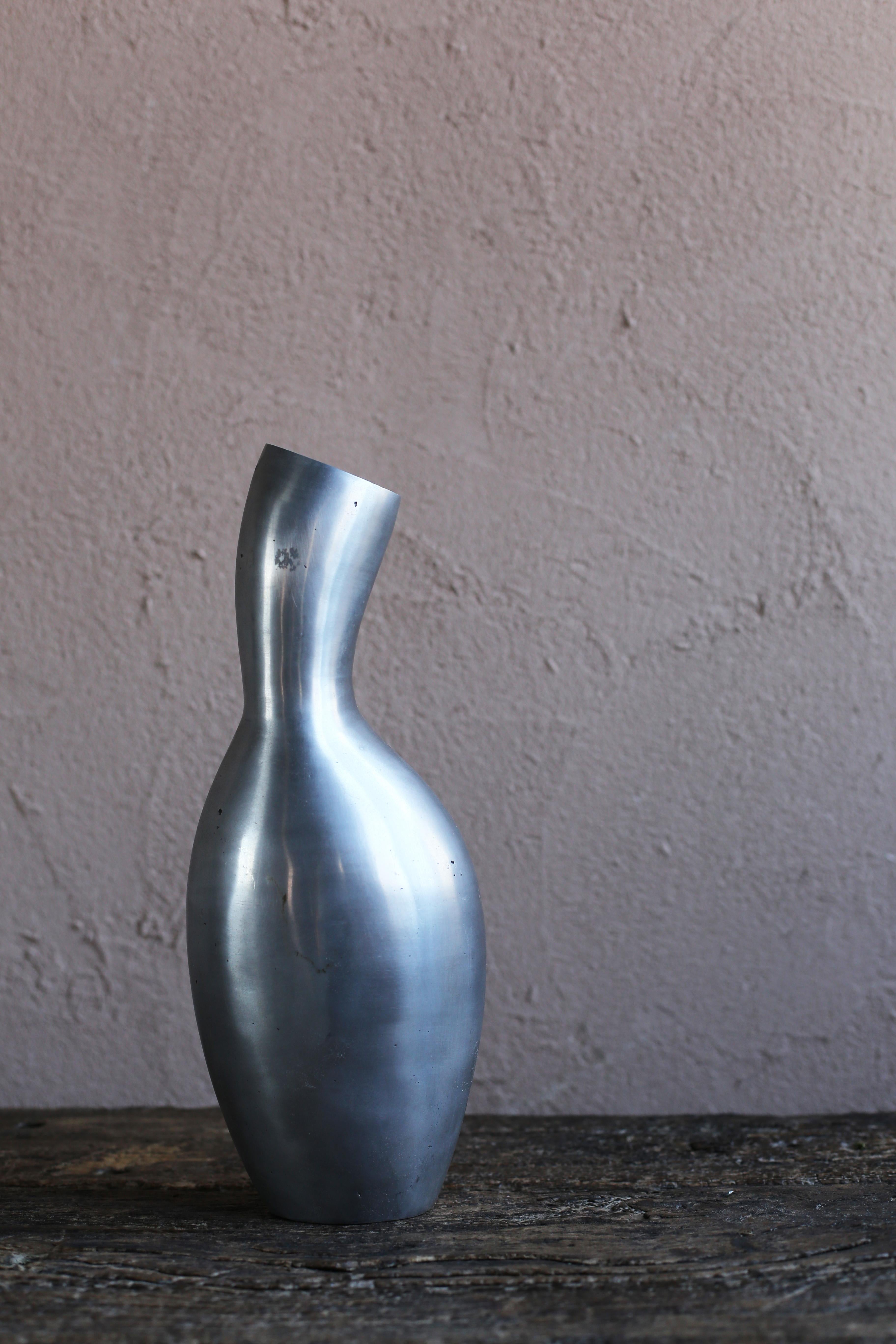 A vintage vase by a Moroccan artist. The artist is unknown. Made of cast aluminum with a unique shape. Polished finish.