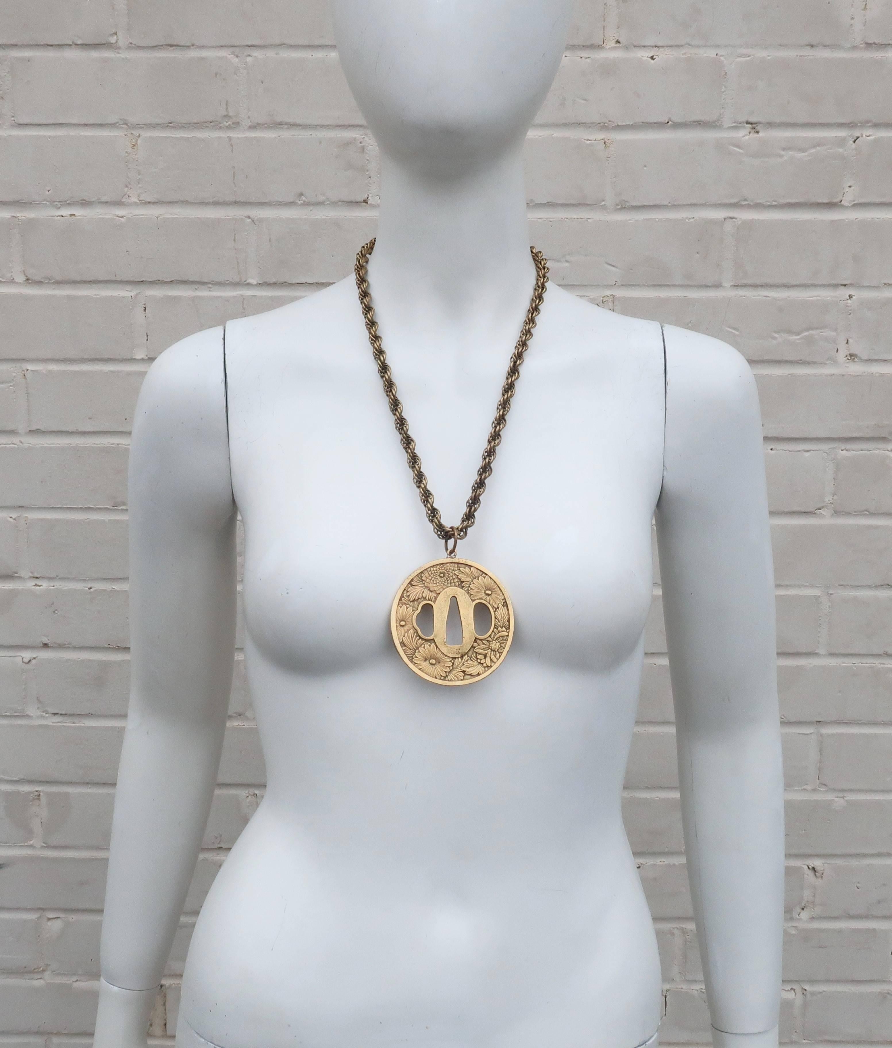 Alva Museum Replicas started designing decorative reproductions of antiquities and sculptures in the 1940’s for marketing in museum gift stores.  This brass medallion necklace is a replica of a Japanese tsuba or sword guard and depicts a