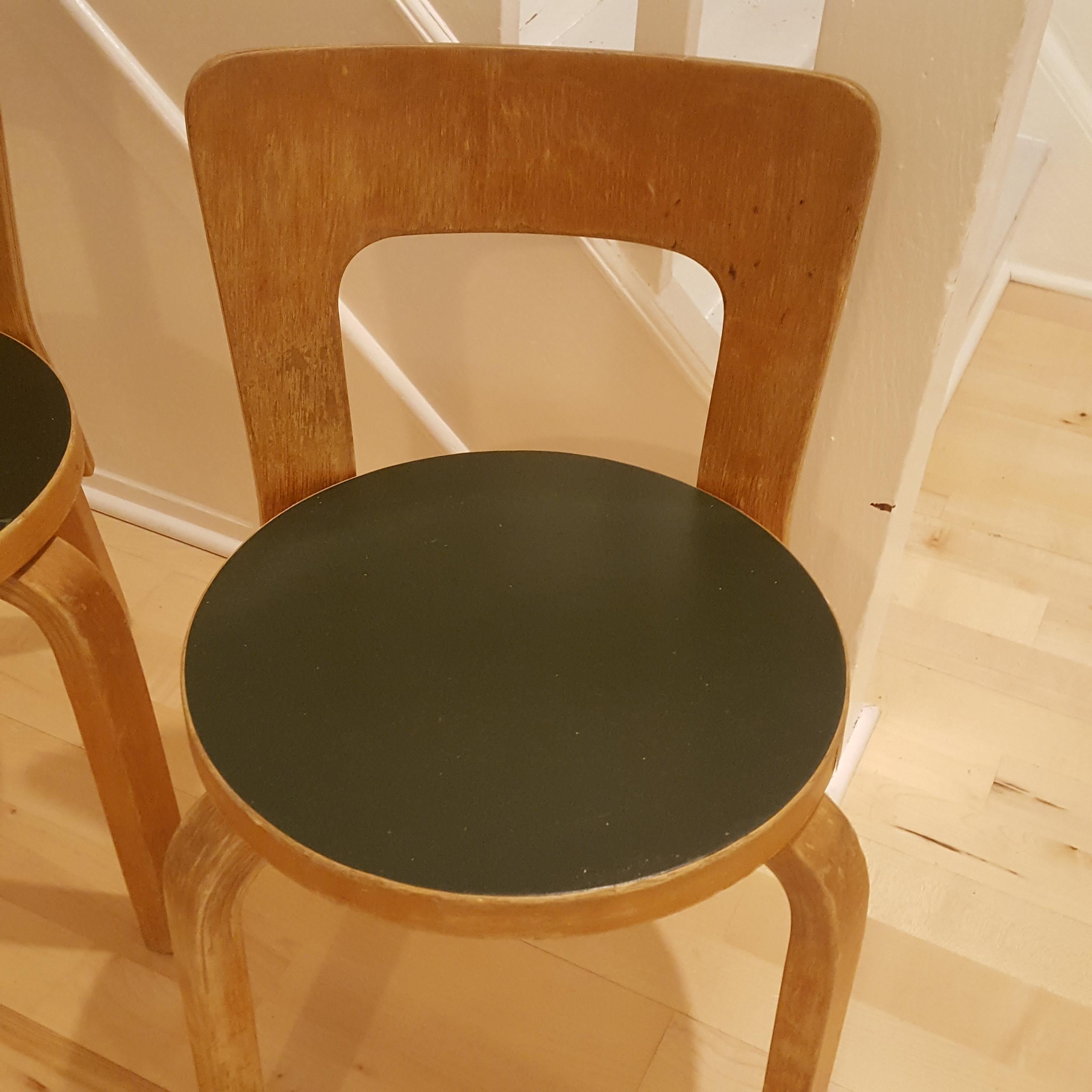A stunning pair of Vintage Alvar Aalto/Artek N65 Children's chairs. The green linoleum seats are in great condition. Lovely patina and still very solid.