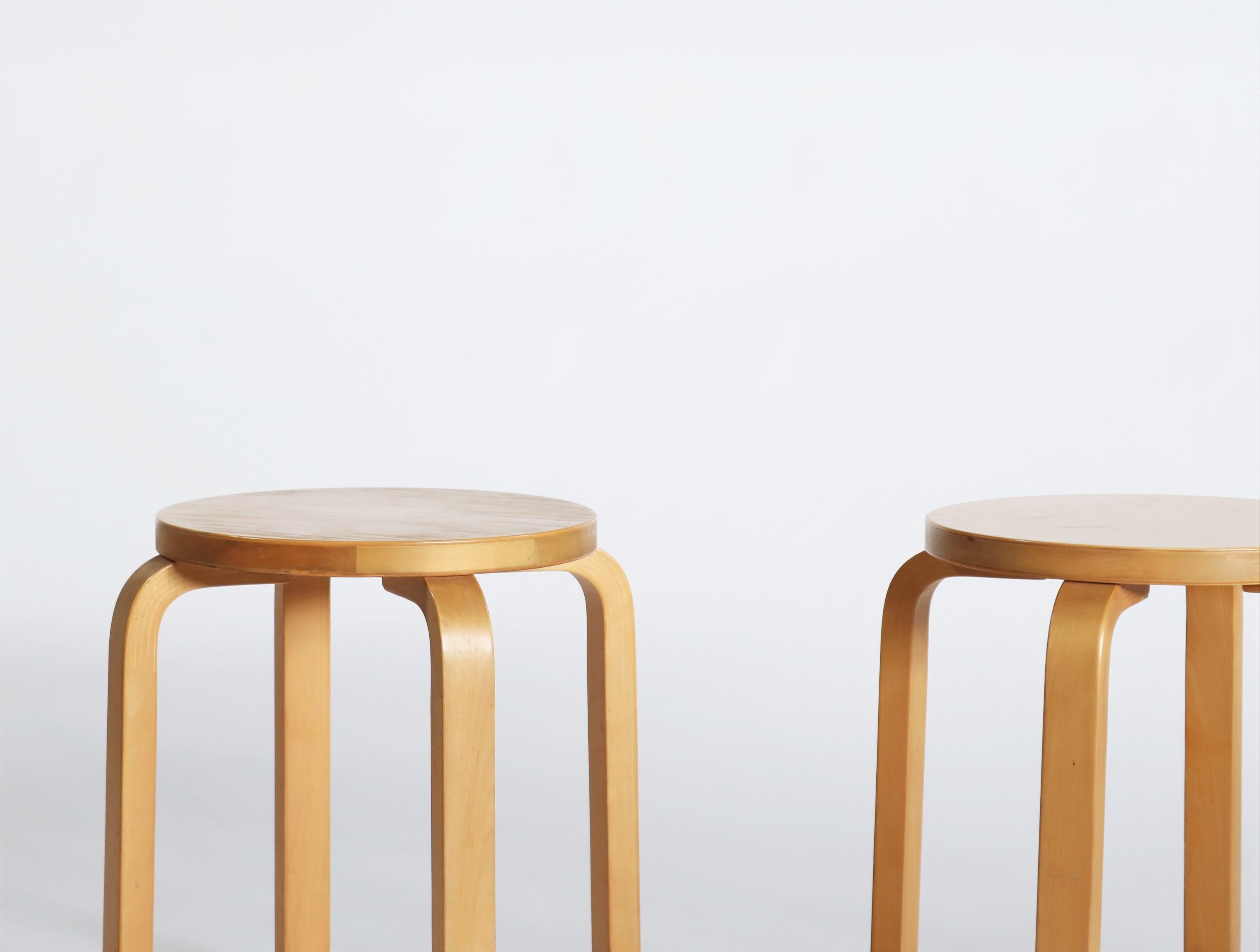 Pair of beautifully patinated stools from the early Artek production. Alvar Aalto’s four-legged stool E60 designed in 1934 is the most elemental of furniture pieces, equally suitable as a seat, table, storage unit, or display surface. Projecting a