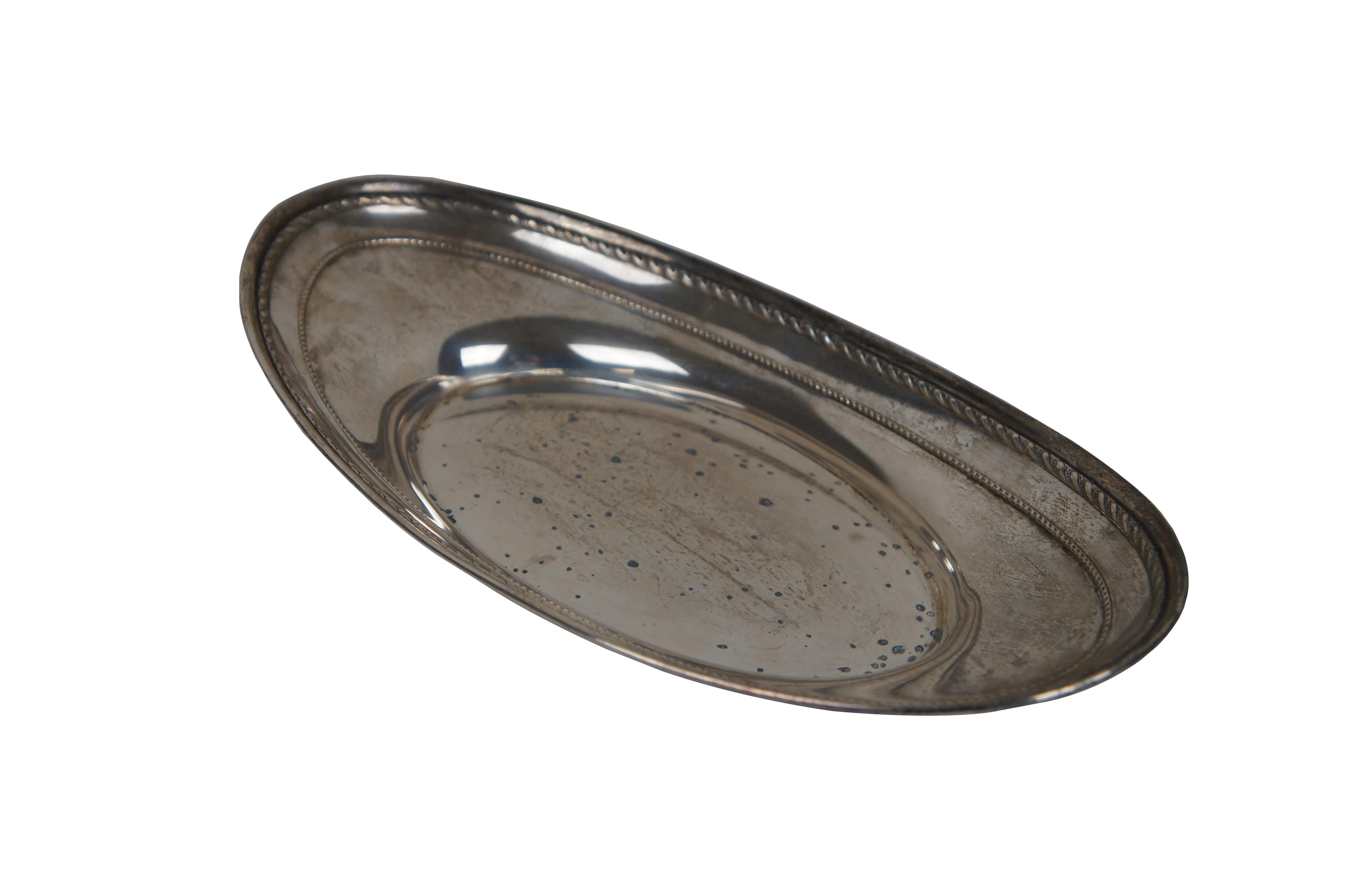 Vintage Alvin sterling silver oval bread tray, number J1011, featuring an oval boat shape with rope twist details.

