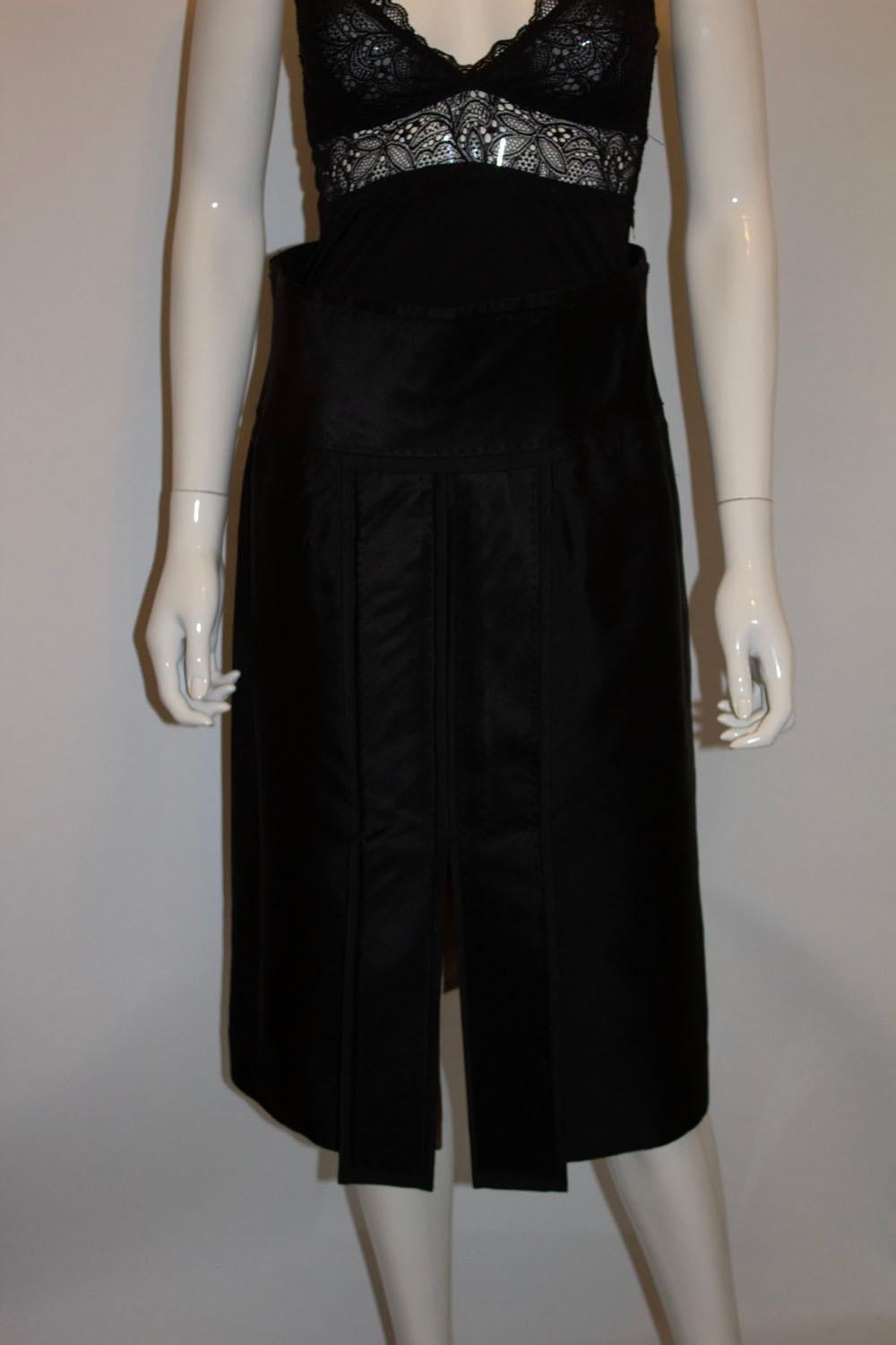 A stunning  vintage black silk skirt by Amanda Wakeley , main line. The skirt has wonderful tailoring and stitch detail, and is fully lined in silk. It has a back central zip and 12 1/2 '' slit at the front. 
UK size 10, measurements. waist 29'',