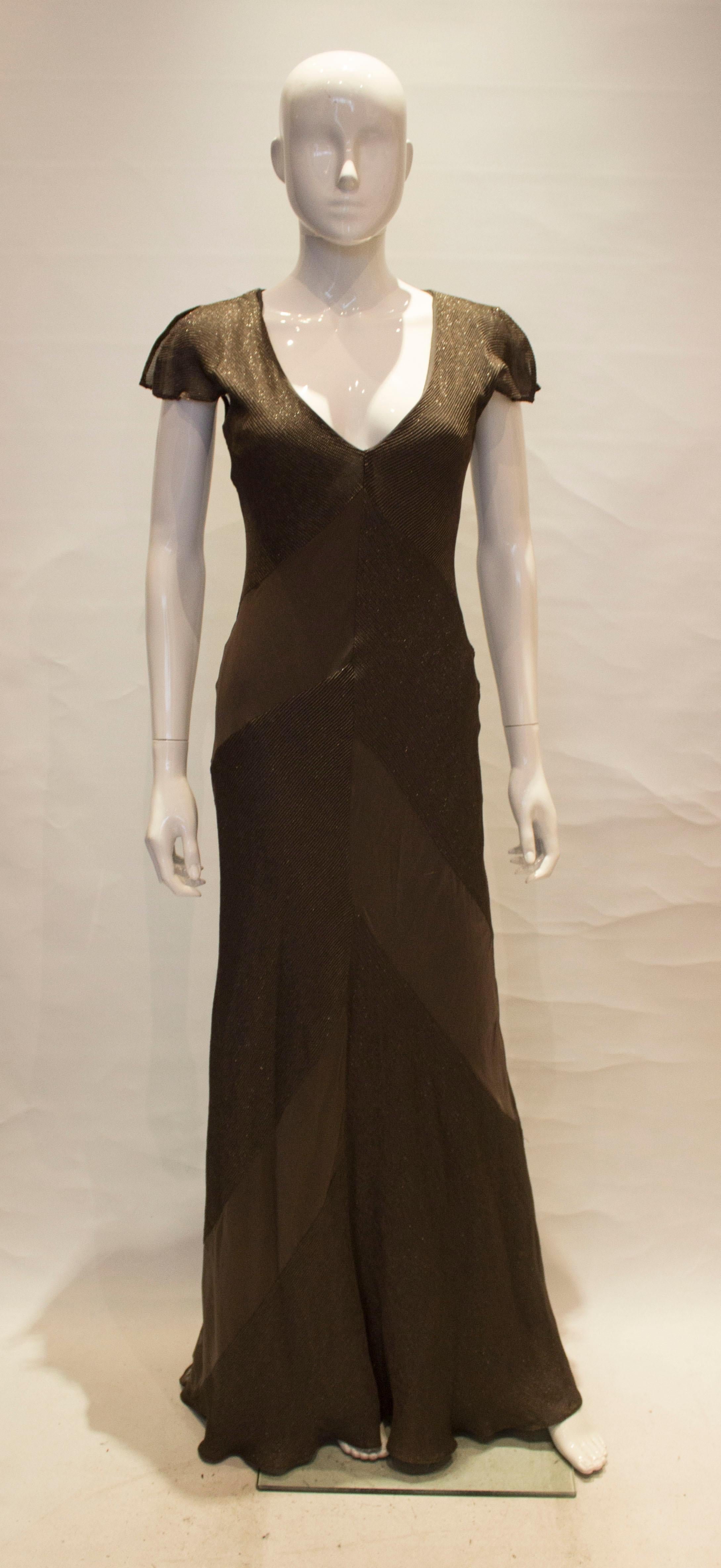 A head turning and easy to wear gown by Amanda Wakeley. The dress has a v neckline, and cap sleaves. It is fully lined and covered in sections of bead work.