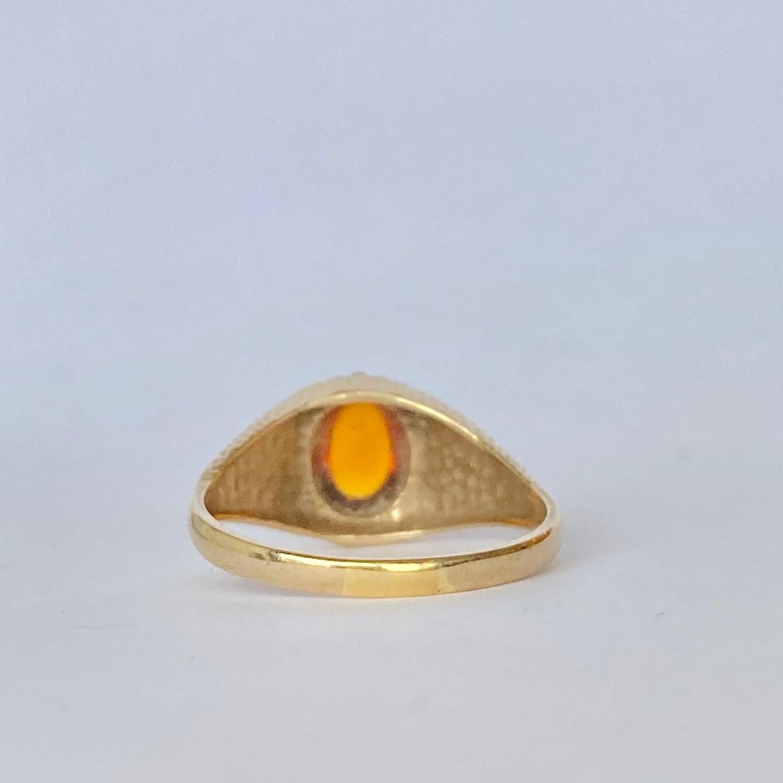 This gorgeous textured band holds an oval cabochon amber. The glow of the amber looks great next to the 9carat gold. Fully hallmarked 1972 London.

Ring Size: S 1/2 or 9 1/2 
Height Off Finger: 8mm

Weight: 3.27g