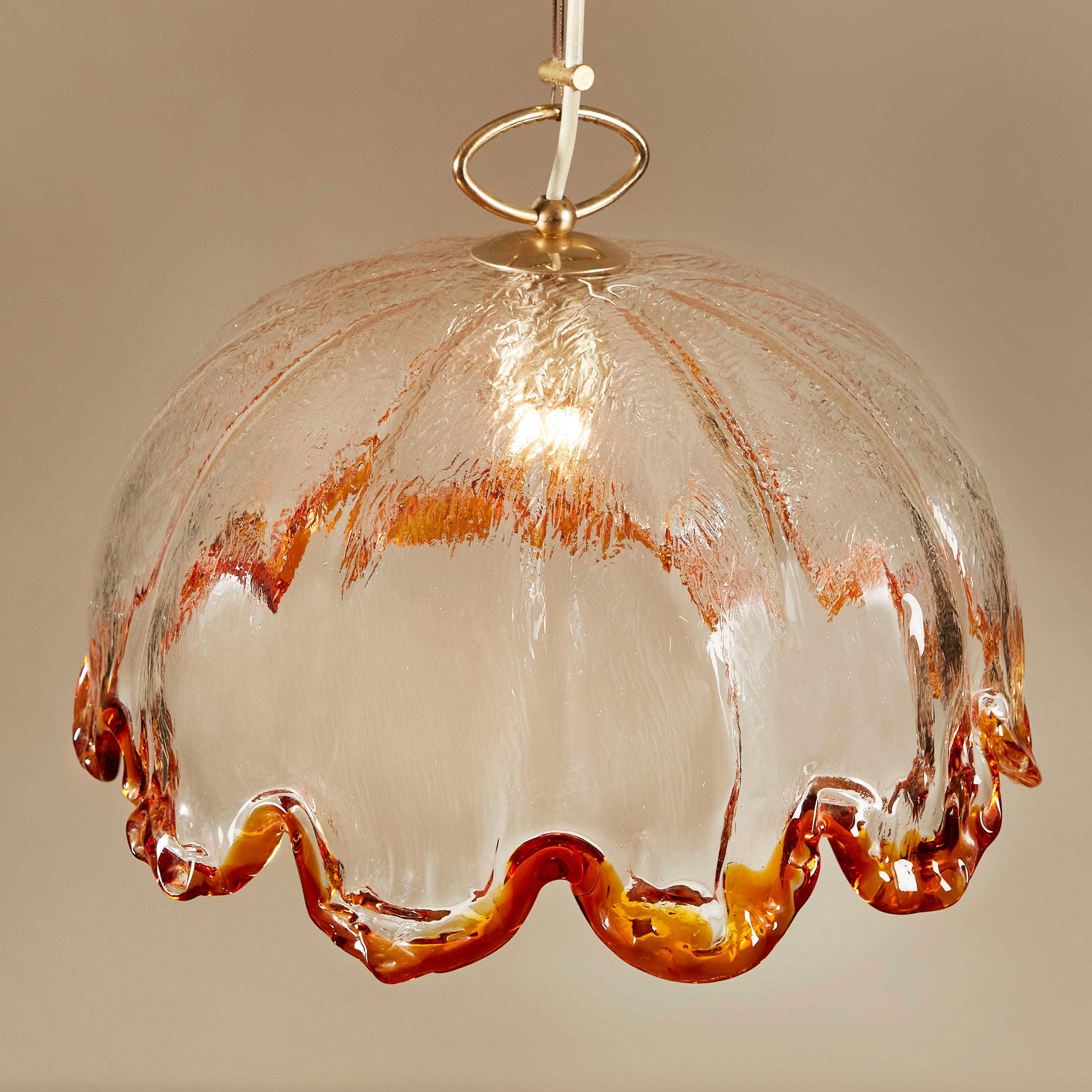 Large beautifully shaped chandelier by the prestigious Murano glass company ‘La Murrina”. Glass shows the original stamp. Thick textured clear glass with rich amber colour to he fluted edge. Decorative brass hardware.