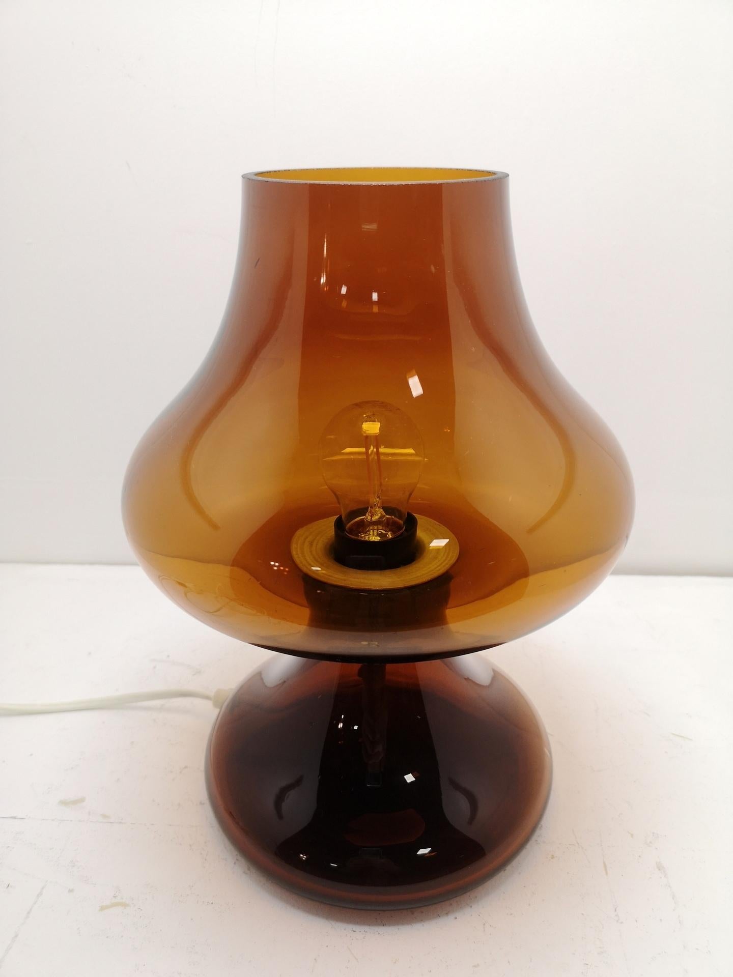 Vintage amber glass lamp: a blown, hand made glass lamp, of one solid piece of glass from the 1970s, in amber or dark honey color. Rare, vintage piece.