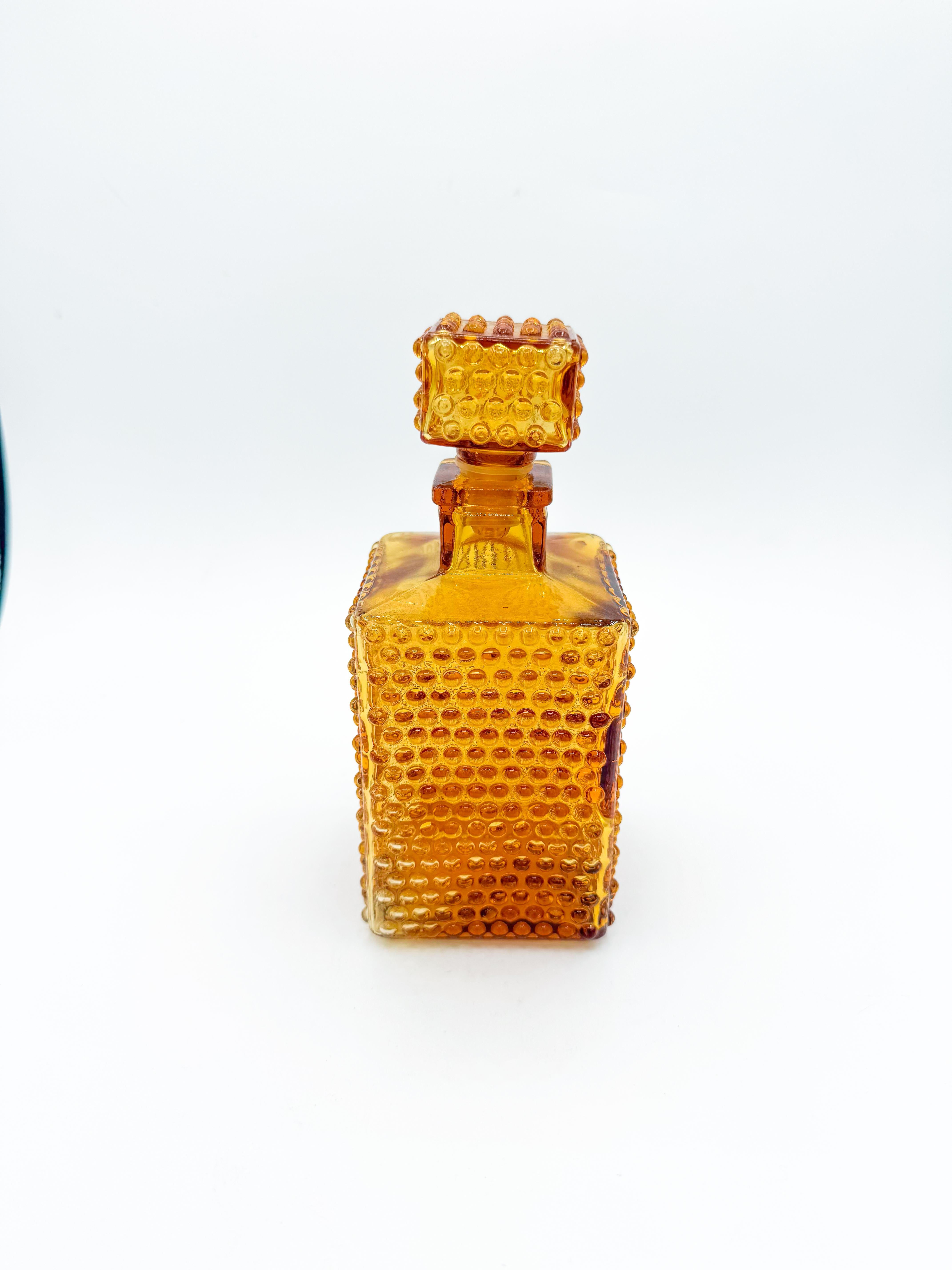 Charming and full of texture, this vintage hobnail decanter carafe brings a refined yet playful touch to any bar or display. Made in Japan in the mid-20th century, it features a striking square silhouette with a classic hobnail pattern throughout,