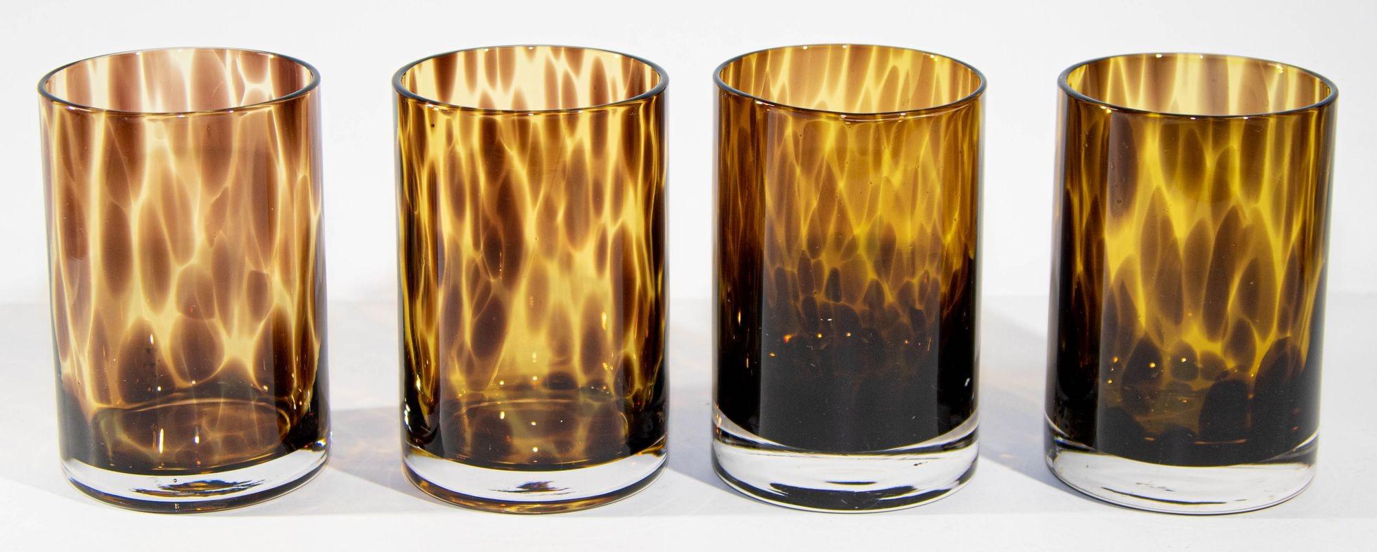 Vintage amber drinking glasses set of four tumbler glasses mouth-blown with exclusive tortoiseshell color flowing pattern.
A distinctive tortoise shell motif brings rich color and dimension to a glass barware set that makes a stunning addition to