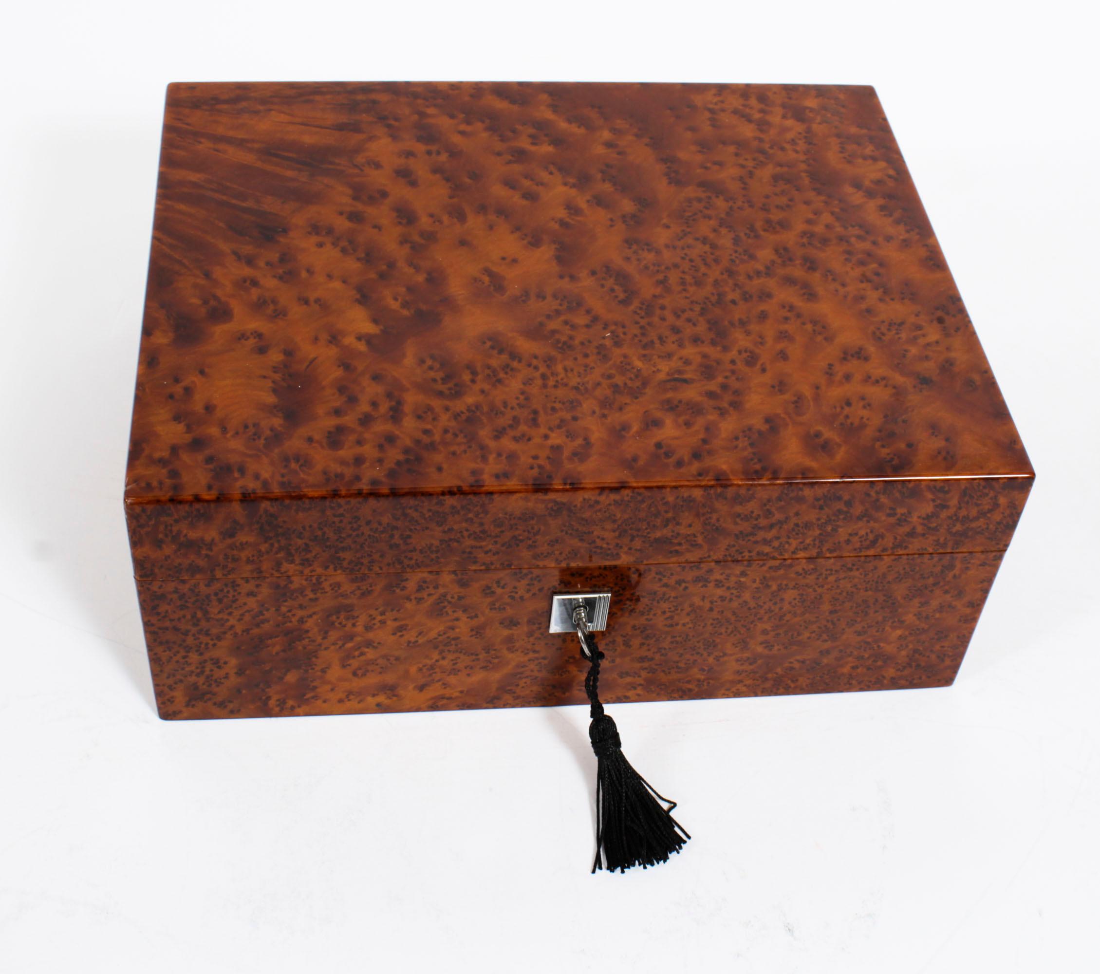 A elegant Dunhill France, amboyna cased cigar humidor casket, dating from the second hald of the 20th Century.

The humidor has a Spanish cedar-lined interior which helps to keep the aroma and is equipped with Passatore humidification system.