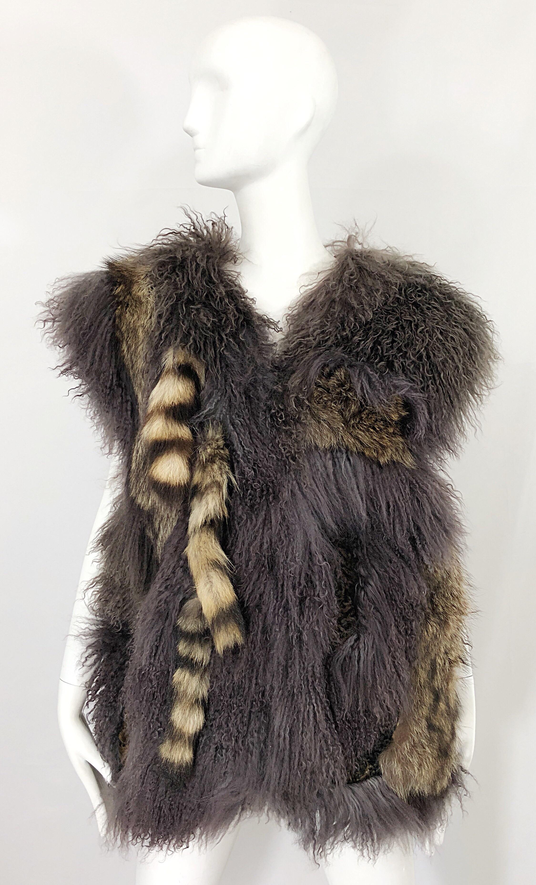 Avant Garde AMEN WARDY 1980s mixed fur and leather grey and brown sleeveless 80s vest! Features luxurious Mongolian fur, Raccoon fur tails, Fox fur, and brown leather throughout. Two strong fabric covered hook-and-eye fur closures up the front.