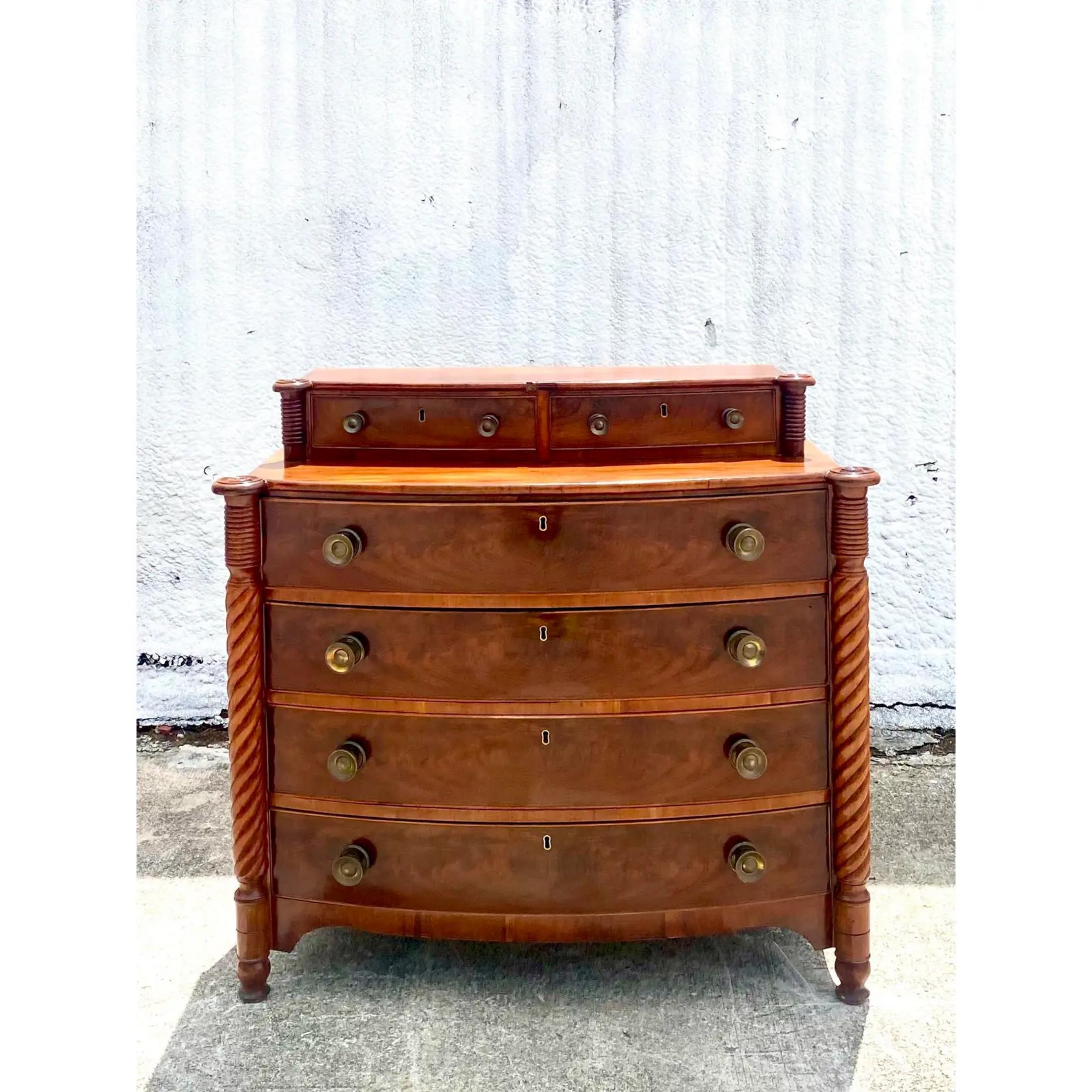 Incredible vintage American chest of drawers. Sheraton style approx 1850s. Beautiful turned wood detail and wood grain detail. Bi level with additional drawers on top. Amazing brass hardware