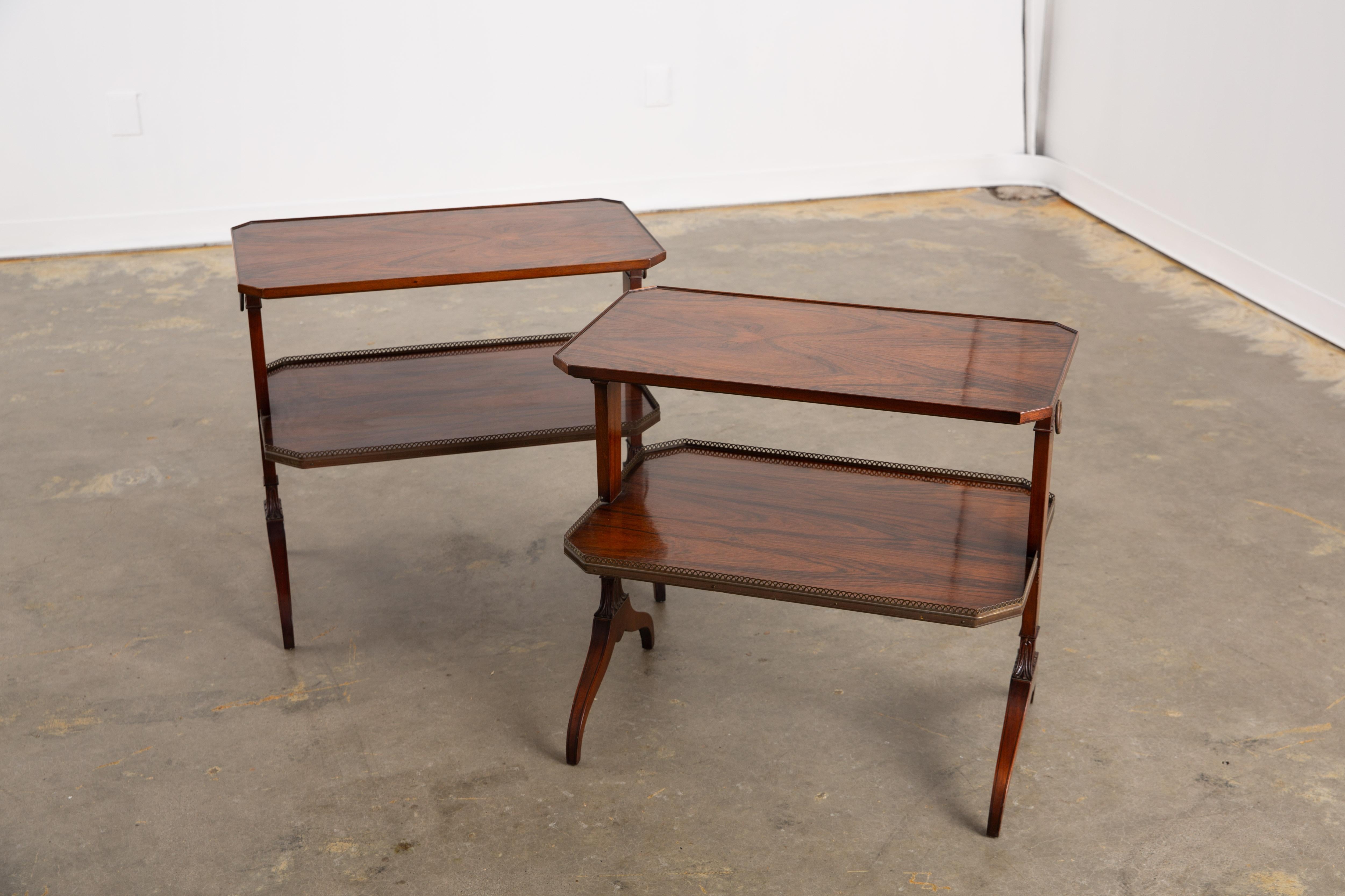 Vintage handmade 1950's marked American Colonial style two-tier side tables by renowned Charak Furniture Company of Boston, Massachusetts. Featuring an elongated hexagonal shape with slightly raised edges, the lower shelf on each table is bordered