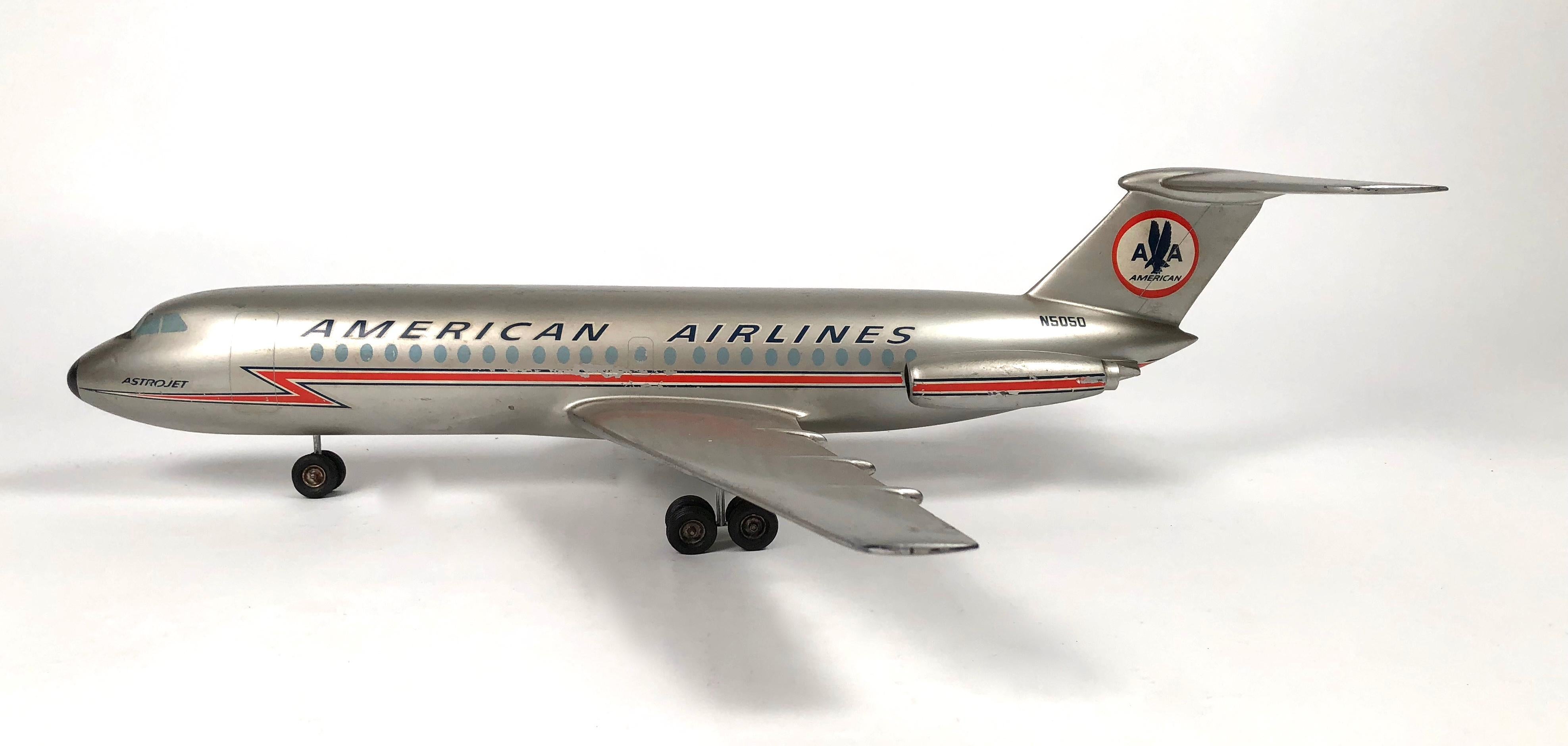 A vintage American Airlines Astrojet aviation model, circa 1950-1960s, in silver painted metal with aircraft livery in red, white and blue, the fuselage and wings with applied decals and extended landing gear. 

Provenance: The Collection of